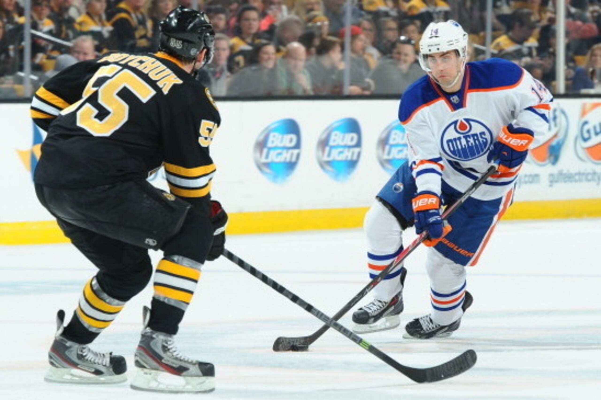 BOSTON, MA - FEBRUARY 1: Jordan Eberle #14 of the Edmonton Oilers skates with the puck against Johnny Boychuk #55 of the Boston Bruins at the TD Garden on February 1, 2014 in Boston, Massachusetts.  (Photo by Steve Babineau/NHLI via Getty Images)