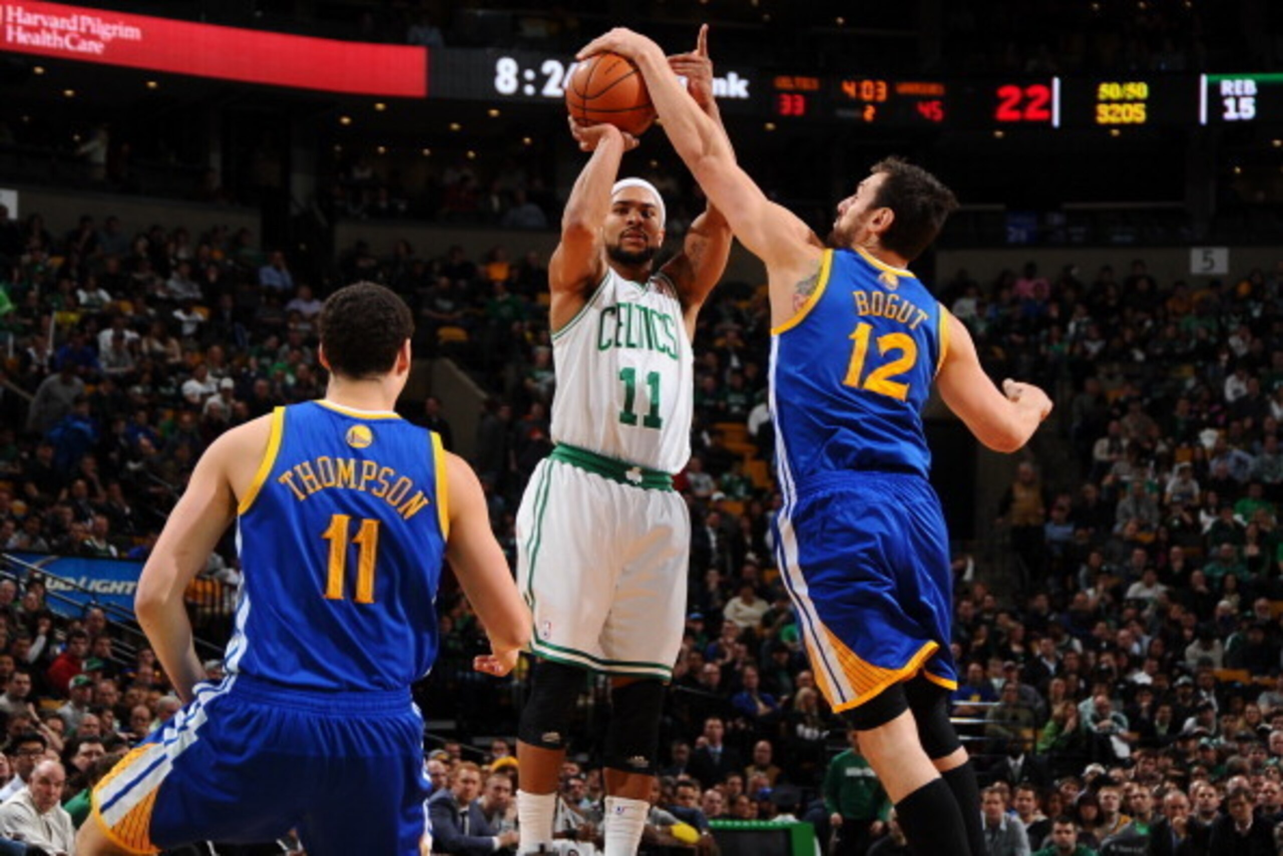 BOSTON, MA - MARCH 5: Andrew Bogut #12 of the Golden State Warriors blocks a shot against Jerryd Bayless #11 of the Boston Celtics on March 5, 2014 at the TD Garden in Boston, Massachusetts.  NOTE TO USER: User expressly acknowledges and agrees that, by d