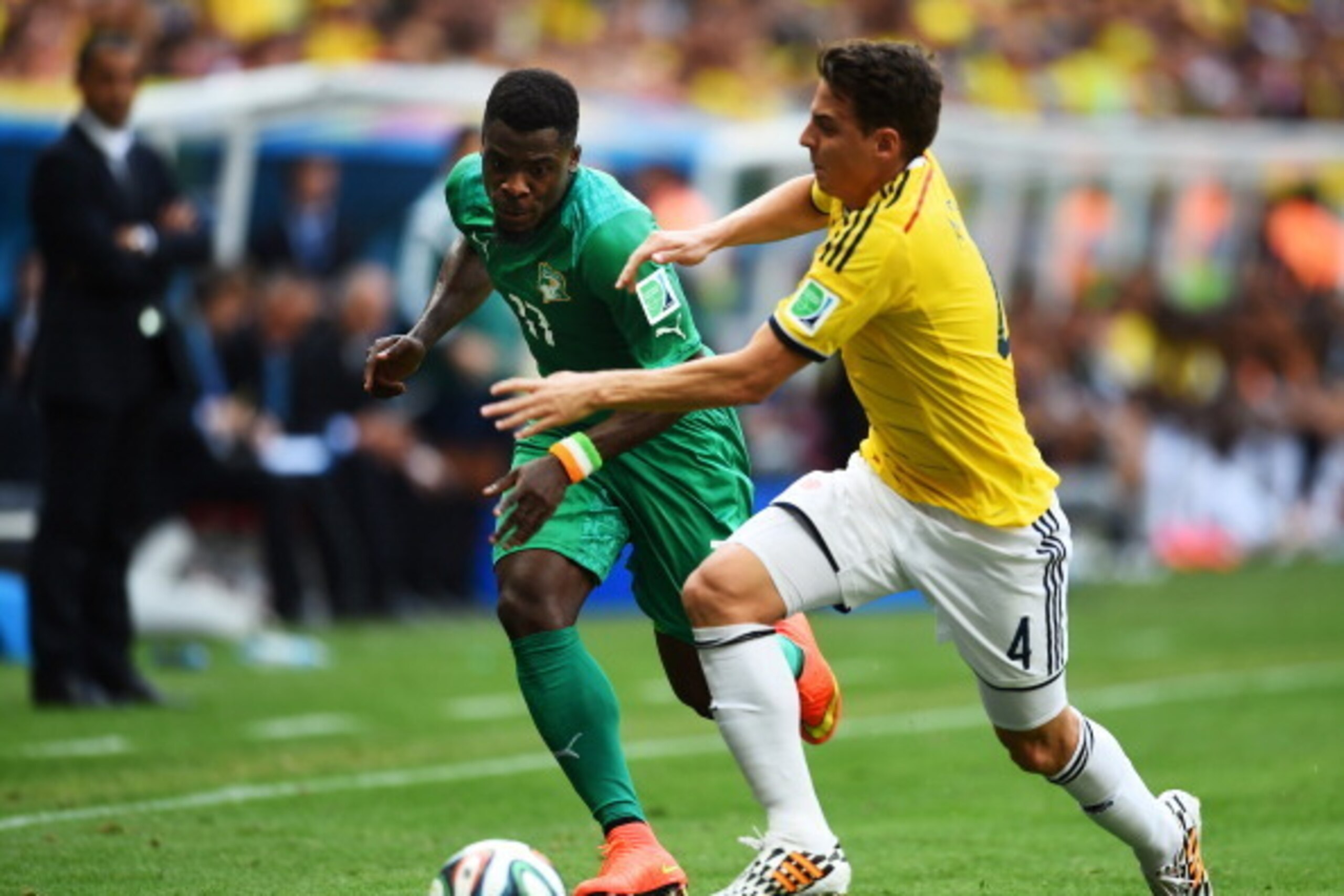 BRASILIA, BRAZIL - JUNE 19:  Serge Aurier of the Ivory Coast and Santiago Arias of Colombia compete for the ball during the 2014 FIFA World Cup Brazil Group C match between Colombia and Cote D'Ivoire at Estadio Nacional on June 19, 2014 in Brasilia, Brazi