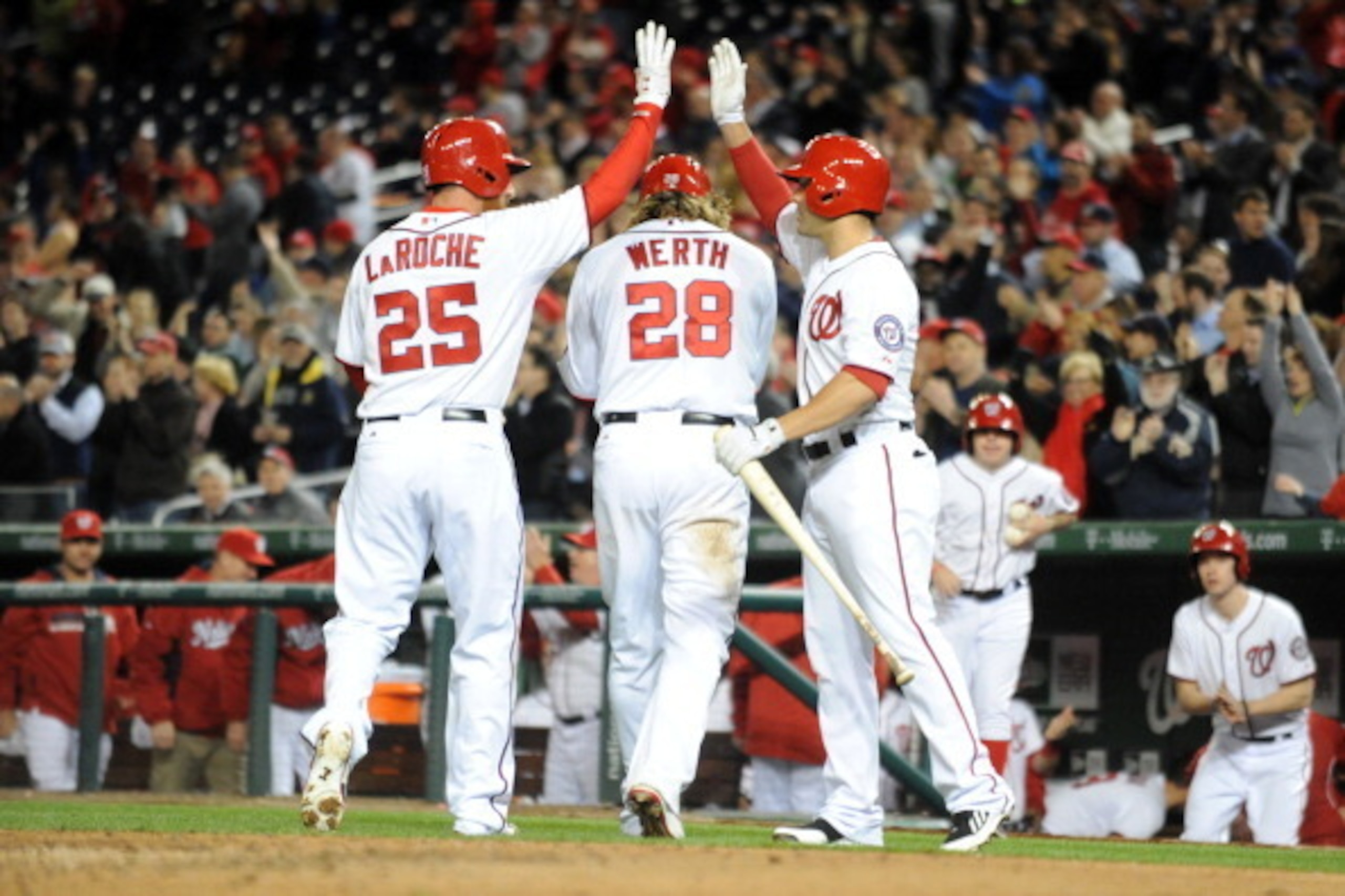 WASHINGTON, DC - APRIL 8:  Adam LaRoche #25 of the Washington Nationals in congratulated by Danny Espinosa #8 after he and Jayson Werth #28 score in the eighth during a baseball against the Miami Marlins on April 8, 2014 at Nationals Park in Washington, D