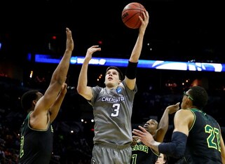 SAN ANTONIO, TX - MARCH 23:  Doug McDermott #3 of the Creighton Bluejays takes a shot as Rico Gathers #2 and Isaiah Austin #21 of the Baylor Bears defend during the third round of the 2014 NCAA Men's Basketball Tournament at the AT&T Center on March 23, 2