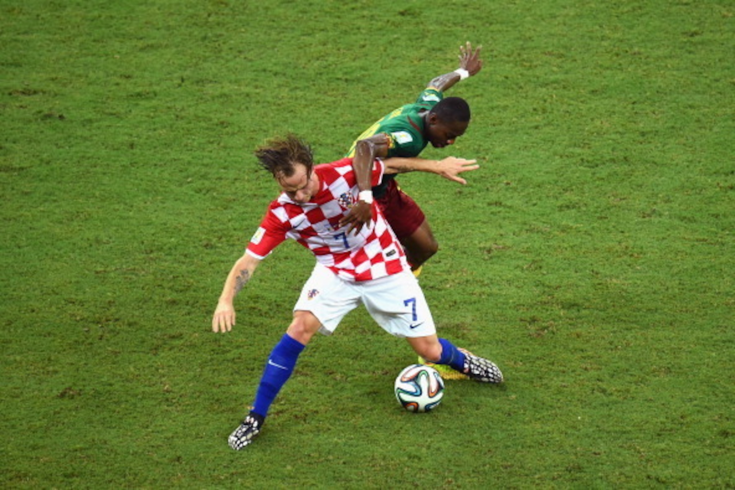 MANAUS, BRAZIL - JUNE 18:  Ivan Rakitic of Croatia and Enoh Eyong of Cameroon compete for the ball  during the 2014 FIFA World Cup Brazil Group A match between Cameroon and Croatia at Arena Amazonia on June 18, 2014 in Manaus, Brazil.  (Photo by Stu Forst