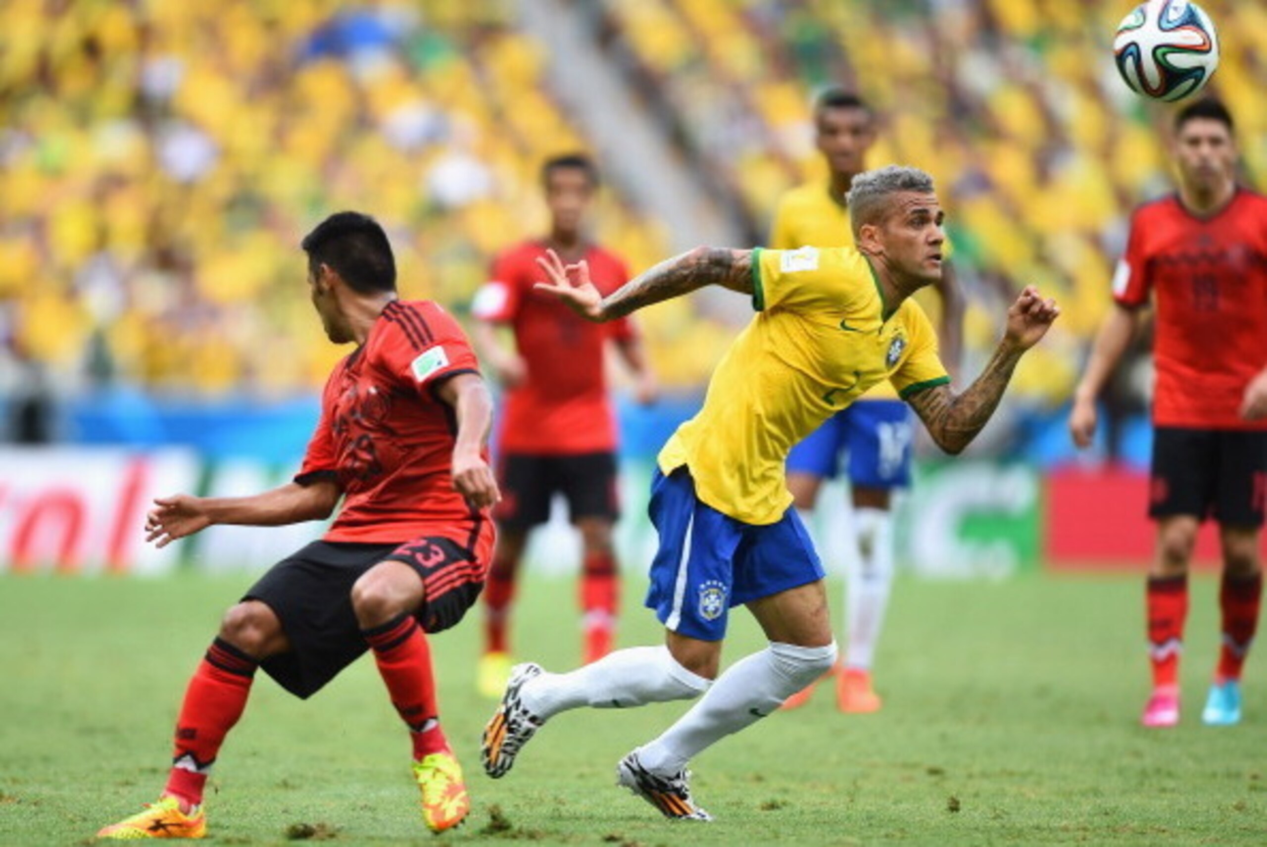FORTALEZA, BRAZIL - JUNE 17: Dani Alves of Brazil turns Francisco Javier Rodriguez of Mexico during the 2014 FIFA World Cup Brazil Group A match between Brazil and Mexico at Castelao on June 17, 2014 in Fortaleza, Brazil.  (Photo by Laurence Griffiths/Get