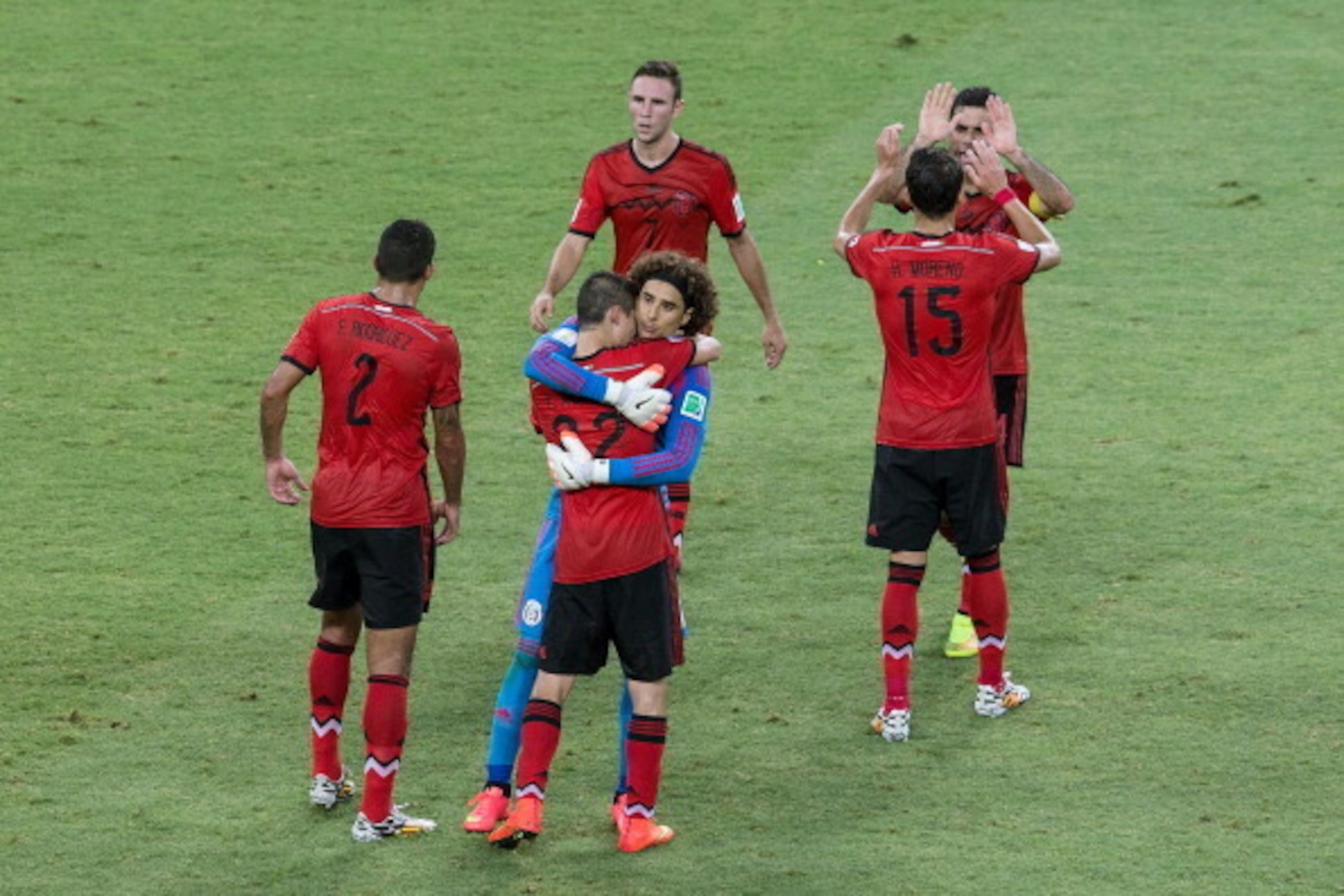 FORTALEZA, BRAZIL - JUNE 17:  Guillermo Ochoa of Mexico embraces with Paul Aguilar after a 0-0 draw 2014 FIFA World Cup Brazil Group A match between Brazil and Mexico at Castelao on June 17, 2014 in Fortaleza, Brazil.  (Photo by Miguel Tovar/Getty Images)