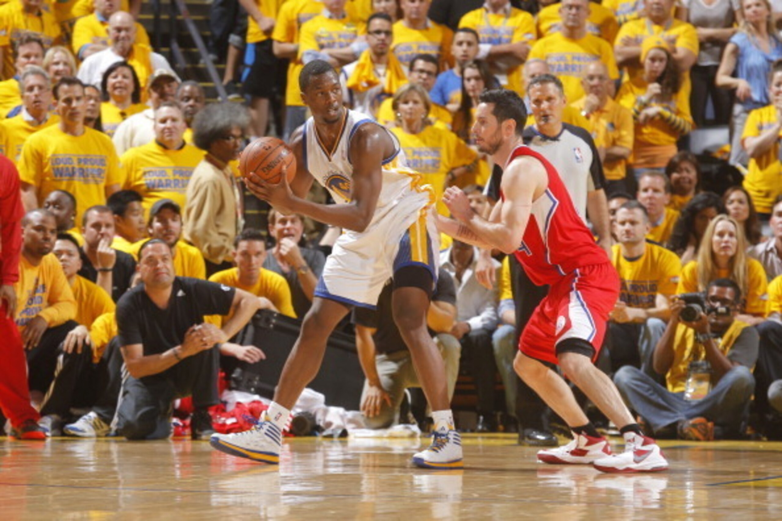 OAKLAND, CA - MAY 1: Harrison Barnes #40 of the Golden State Warriors handles the ball against J.J. Redick #4 of the Los Angeles Clippers in Game Six of the Western Conference Quarterfinals during the 2014 NBA Playoffs at Oracle Arena on May 1, 2014 in Oa