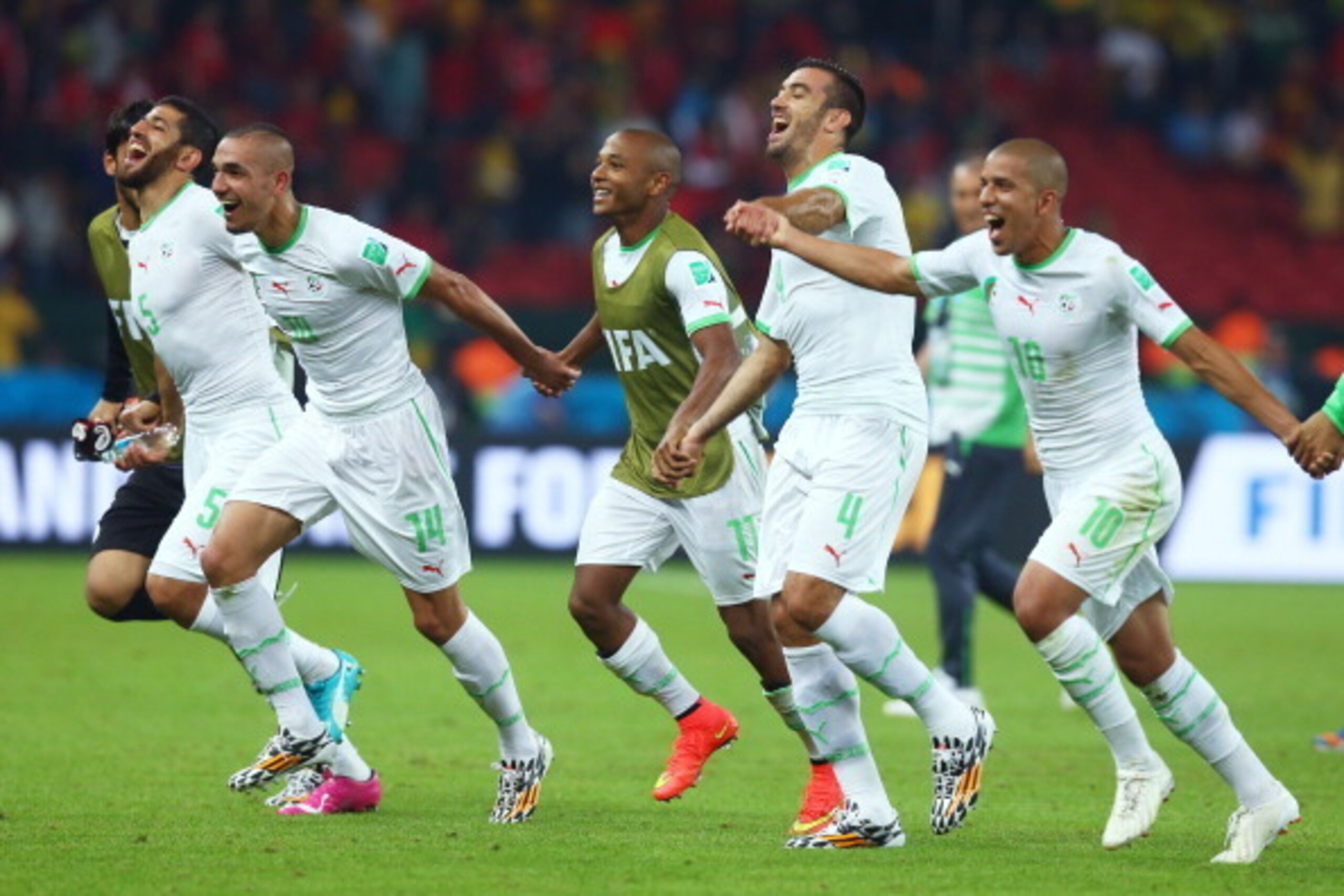PORTO ALEGRE, BRAZIL - JUNE 22:  Algeria celebrate after defeating South Korea 4-2 during the 2014 FIFA World Cup Brazil Group H match between South Korea and Algeria at Estadio Beira-Rio on June 22, 2014 in Porto Alegre, Brazil.  (Photo by Jeff Gross/Get