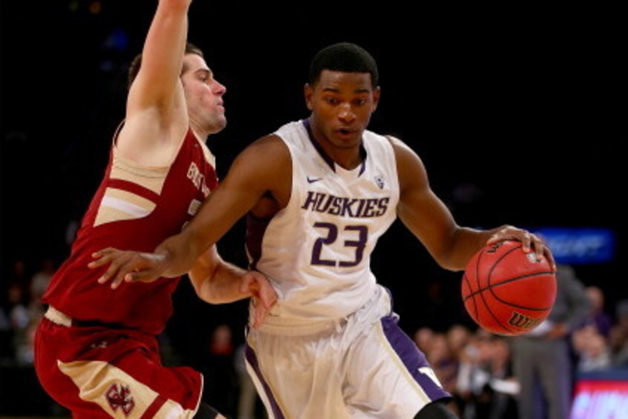 NEW YORK, NY - NOVEMBER 22:  C.J. Wilcox #23 of the Washington Huskies heads for the net as Alex Dragicevich #23 of the Boston College Eagles defends during the 2K Sports Classic at Madison Square Garden on November 22, 2013 in New York City.  (Photo by E