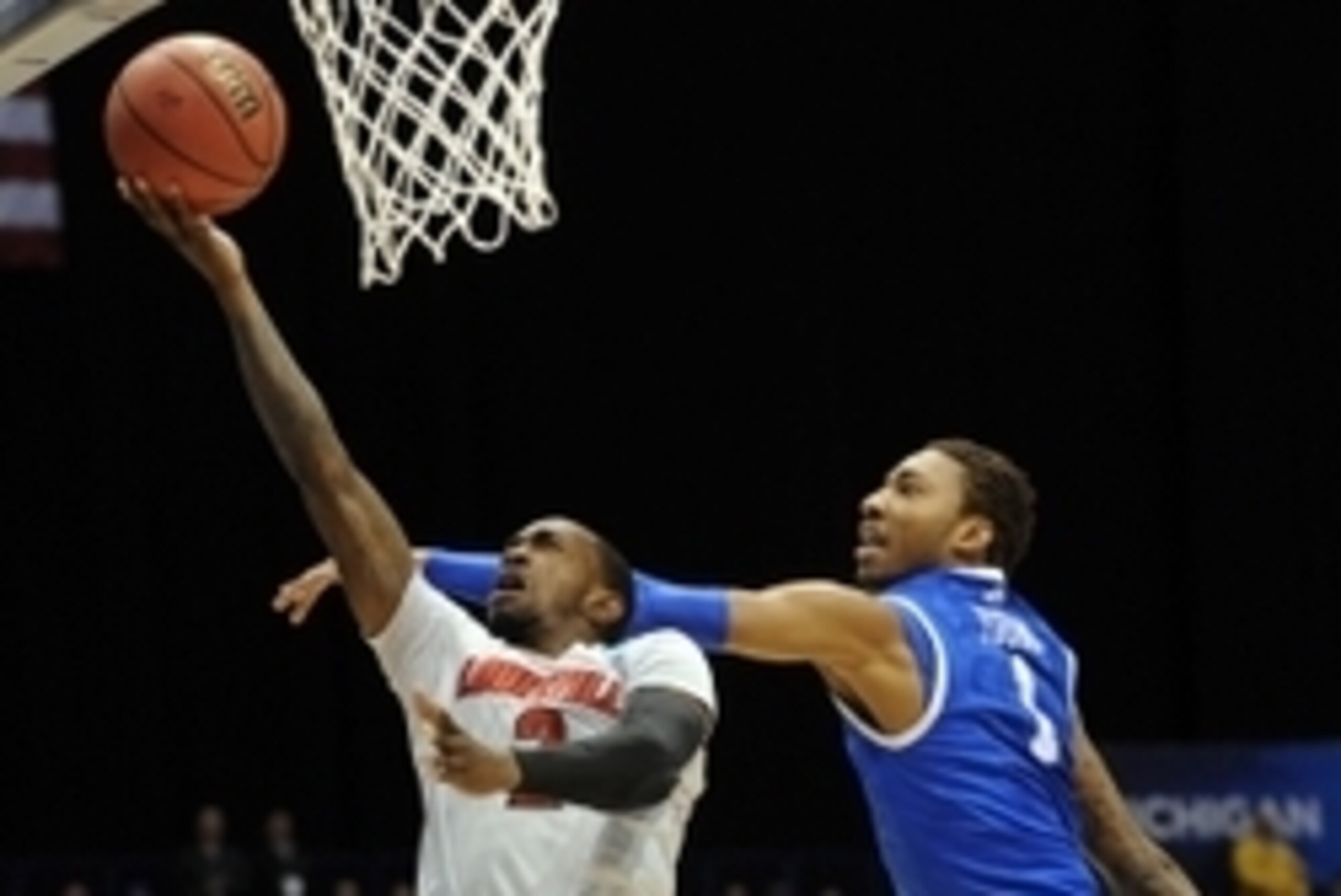 Mar 28, 2014; Indianapolis, IN, USA;  Louisville Cardinals guard Russ Smith (2) shoots against Kentucky Wildcats guard Andrew Harrison (5) in the first half in the semifinals of the midwest regional of the 2014 NCAA Mens Basketball Championship tournament