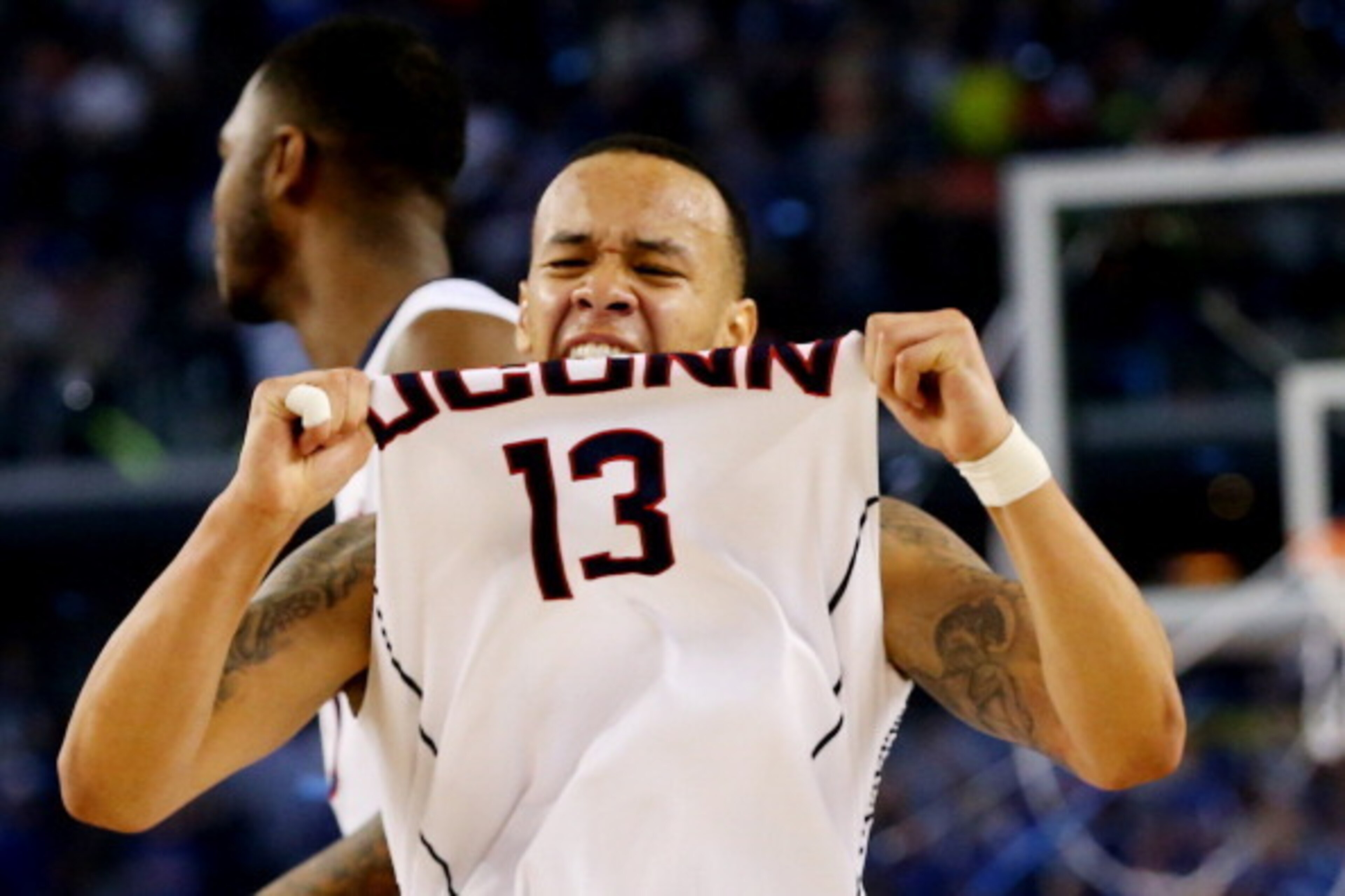 ARLINGTON, TX - APRIL 07:  Shabazz Napier #13 of the Connecticut Huskies celebrates on the court after defeating the Kentucky Wildcats 60-54 in the NCAA Men's Final Four Championship at AT&T Stadium on April 7, 2014 in Arlington, Texas.  (Photo by Ronald 