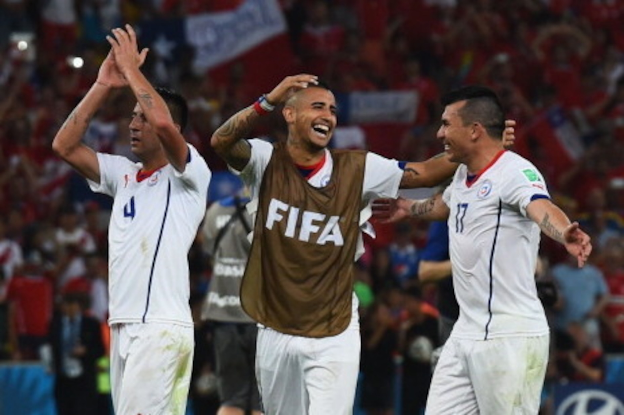RIO DE JANEIRO, BRAZIL - JUNE 18:  (L-R) Mauricio Isla, Arturo Vidal and Gary Medel of Chile celebrate victory after the 2014 FIFA World Cup Brazil Group B match between Spain and Chile at Maracana on June 18, 2014 in Rio de Janeiro, Brazil.  (Photo by Ma