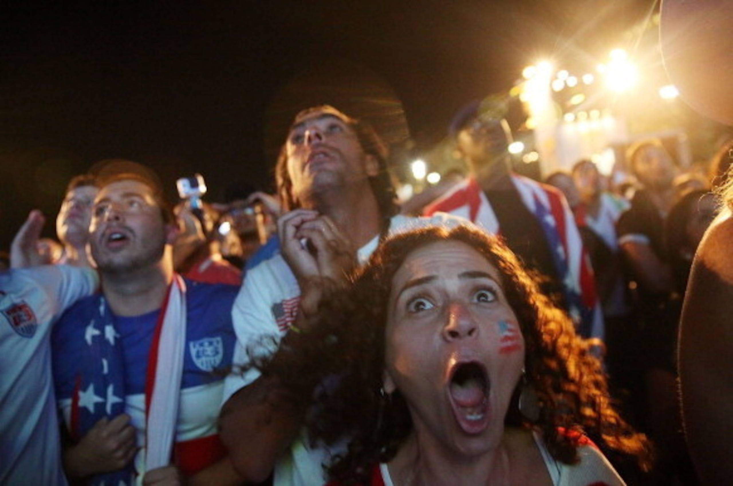 RIO DE JANEIRO, BRAZIL - JUNE 22:  American fans react as Portugal scores a last-minute goal to tie the U.S. 2-2 while watching at the FIFA Fan Fest on Copacabana Beach during the 2014 FIFA World Cup Brazil on June 22, 2014 in Rio de Janeiro, Brazil. The 