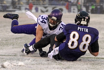 BALTIMORE, MD - DECEMBER 08: Tight end Dennis Pitta #88 of the Baltimore Ravens scores a touchdown past free safety Andrew Sendejo #34 of the Minnesota Vikings in the fourth quarter at M&T Bank Stadium on December 8, 2013 in Baltimore, Maryland. The Balti