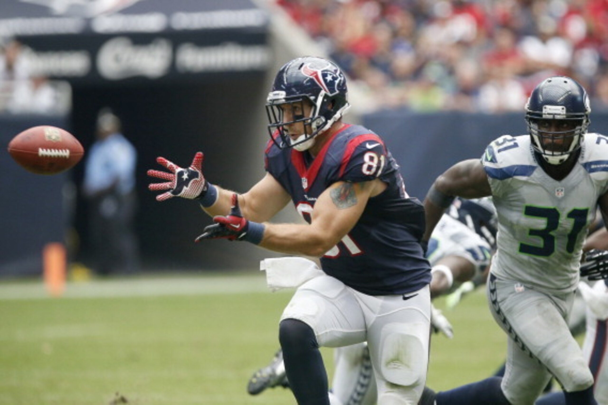 HOUSTON, TX- SEPTEMBER 29: Owen Daniels #81 of the Houston Texans makes the catch while Kam Chancellor #31 of the Seattle Seahawks defends on the play on September 29, 2013 at Reliant Stadium in Houston, Texas. (Photo by Thomas B. Shea/Getty Images)