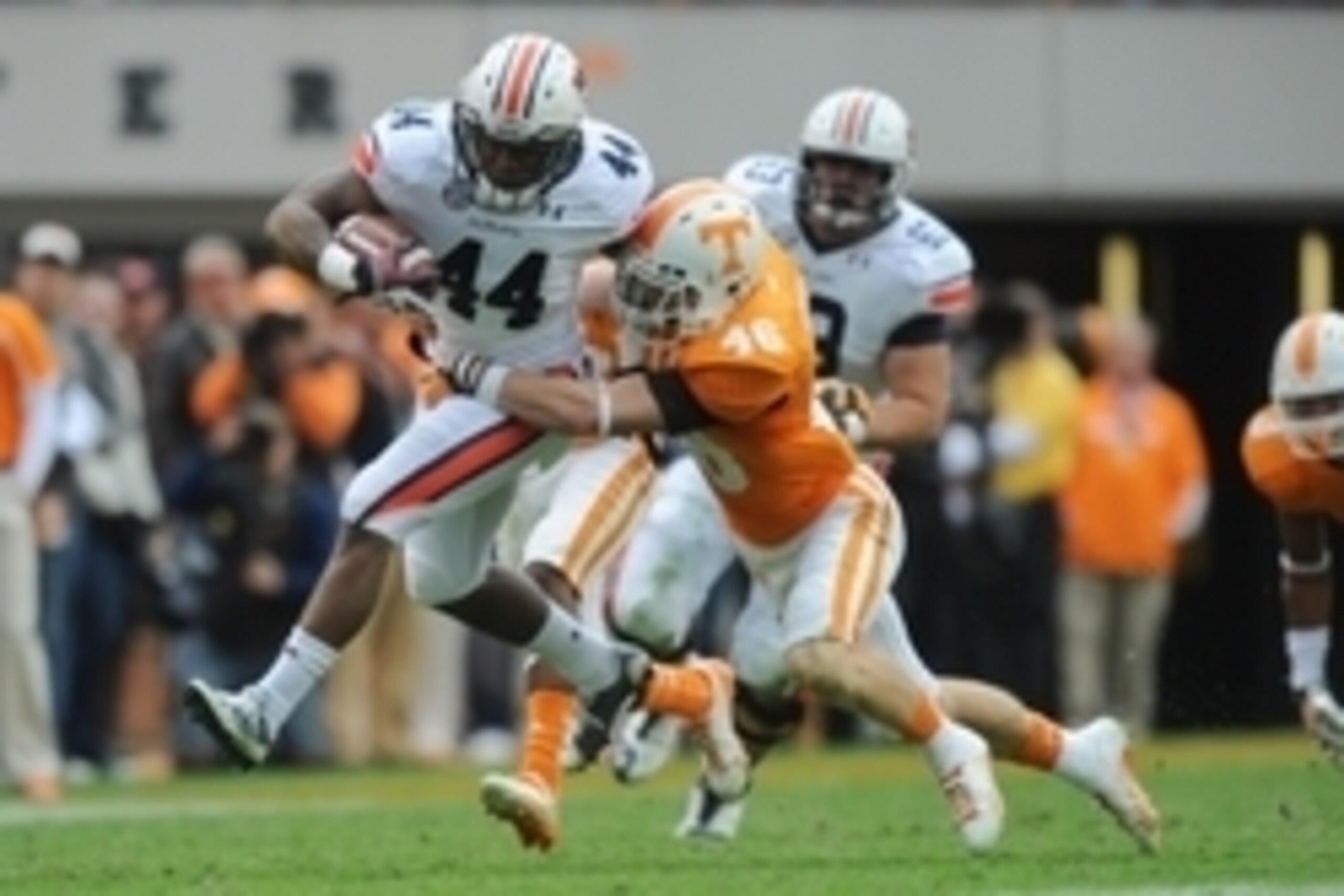 Nov 9, 2013; Knoxville, TN, USA; Auburn Tigers running back Cameron Artis-Payne (44) runs the ball against Tennessee Volunteers defensive back Max Arnold (46) during the second half at Neyland Stadium. Auburn won 55 to 23. Mandatory Credit: Randy Sartin-U