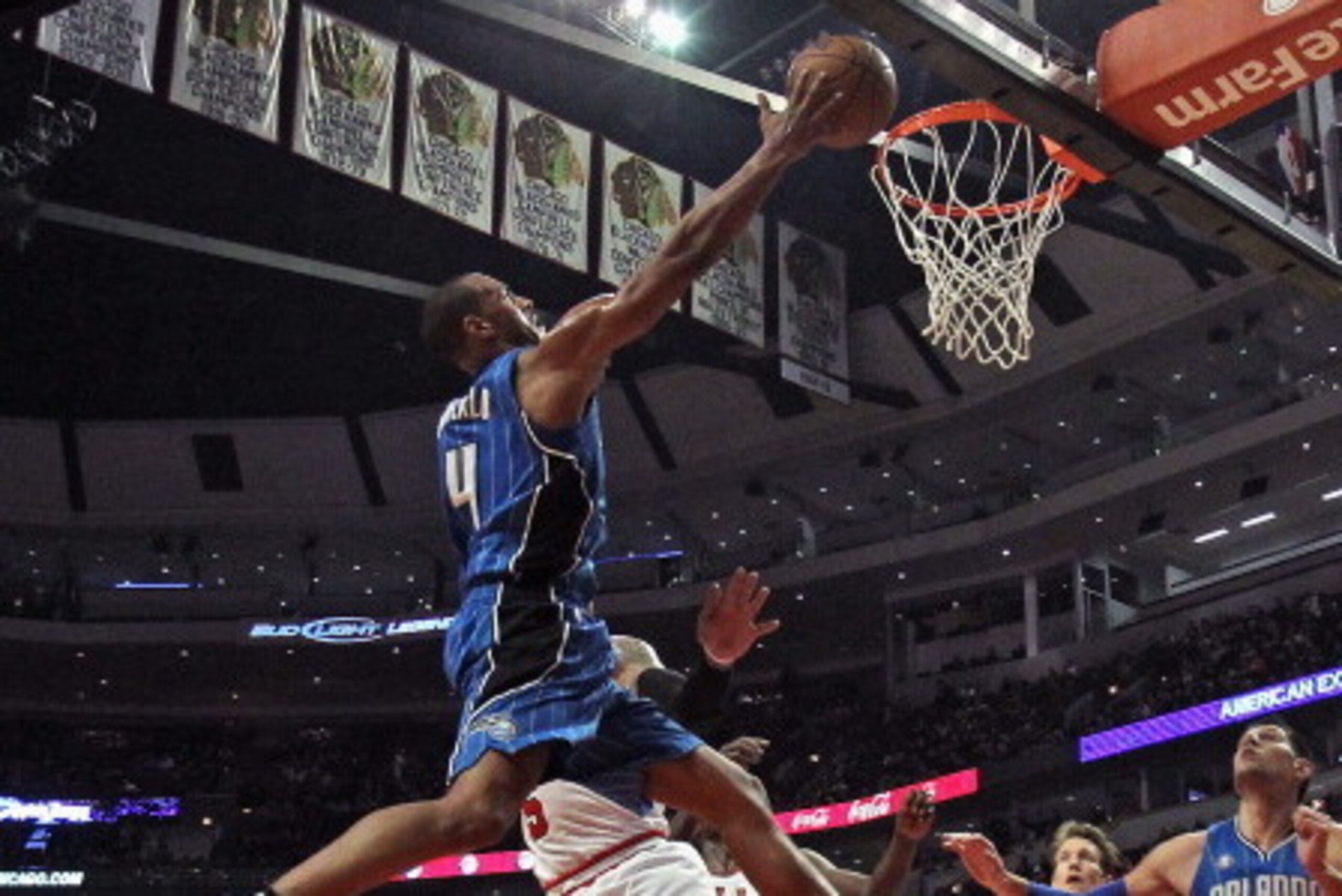 CHICAGO, IL - DECEMBER 16:  Arron Afflalo #4 of the Orlando Magic puts up a shot against Carlos Boozer #5 of the Chicago Bulls at the United Center on December 16, 2013 in Chicago, Illinois. NOTE TO USER: User expressly acknowledges and agrees that, by do
