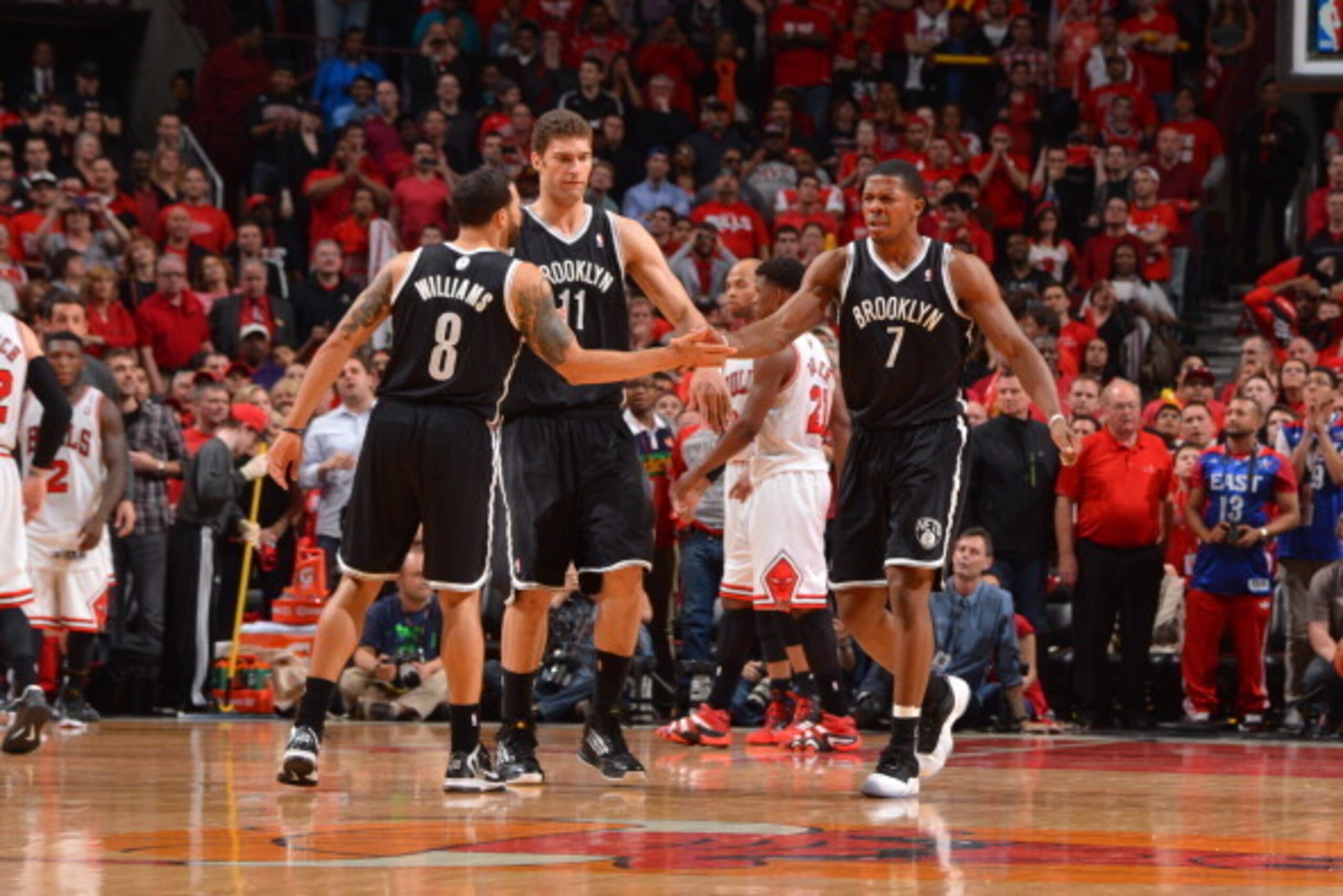 CHICAGO, IL - APRIL 27: Joe Johnson #7 of the Brooklyn Nets is congratulated by teammates Deron Williams #8 and Brook Lopez #11 after hitting a shot that tied the game and forced a second overtime period in Game Four of the Eastern Conference Quarterfinal