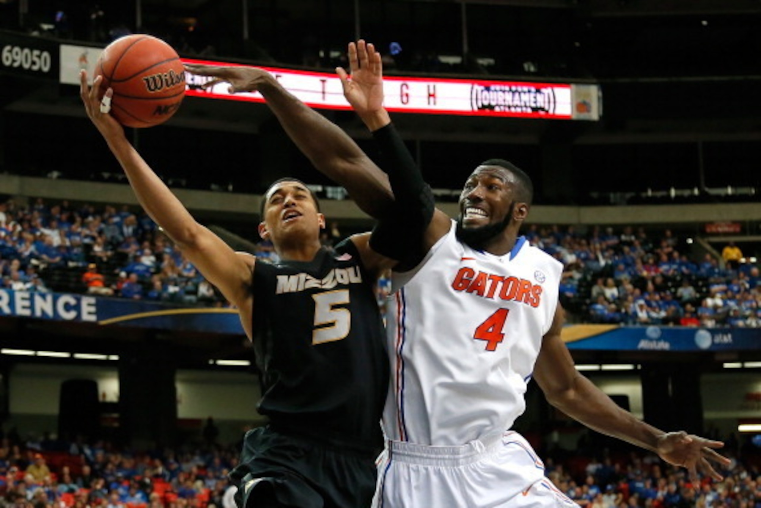 ATLANTA, GA - MARCH 14:  Patric Young #4 of the Florida Gators defends against Jordan Clarkson #5 of the Missouri Tigers during the quarterfinals of the SEC Men's Basketball Tournament at Georgia Dome on March 14, 2014 in Atlanta, Georgia.  (Photo by Kevi
