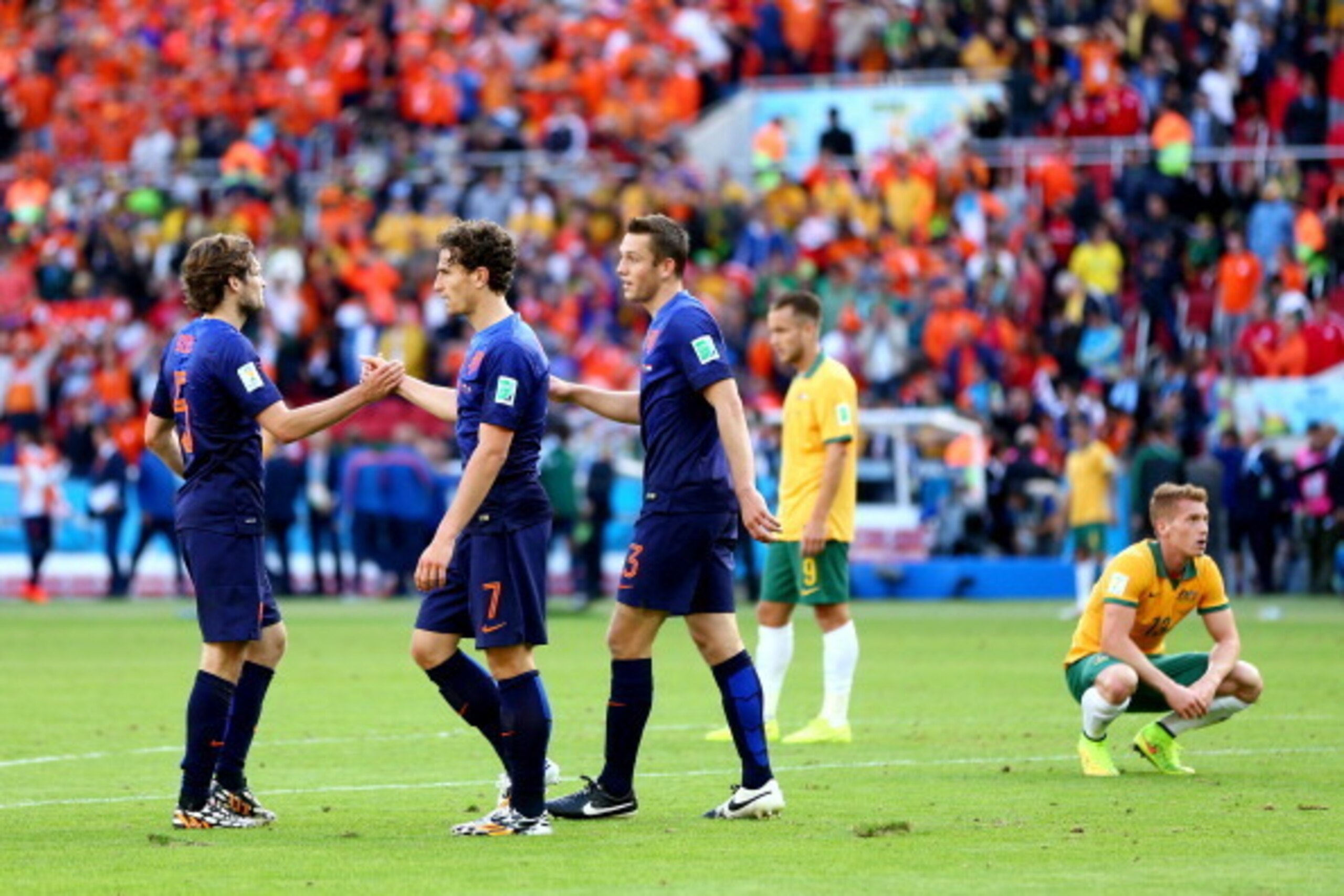 PORTO ALEGRE, BRAZIL - JUNE 18: (L-R) Daley Blind, Daryl Janmaat and Stefan de Vrij of the Netherlands celebrate after defeating Australia 3-2 during the 2014 FIFA World Cup Brazil Group B match between Australia and Netherlands at Estadio Beira-Rio on Ju