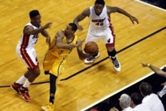 May 24, 2014; Miami, FL, USA; Indiana Pacers guard George Hill (3) guarded by Miami Heat guard Norris Cole (30) and forward Udonis Haslem (40) in game three of the Eastern Conference Finals of the 2014 NBA Playoffs at American Airlines Arena. Mandatory Cr