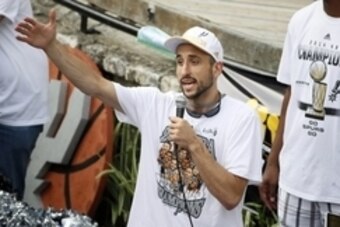 Jun 18, 2014; San Antonio, TX, USA; San Antonio Spurs guard Manu Ginobili (20) reacts to cheering fans during the NBA championship parade at San Antonio River Walk. Mandatory Credit: Soobum Im-USA TODAY Sports