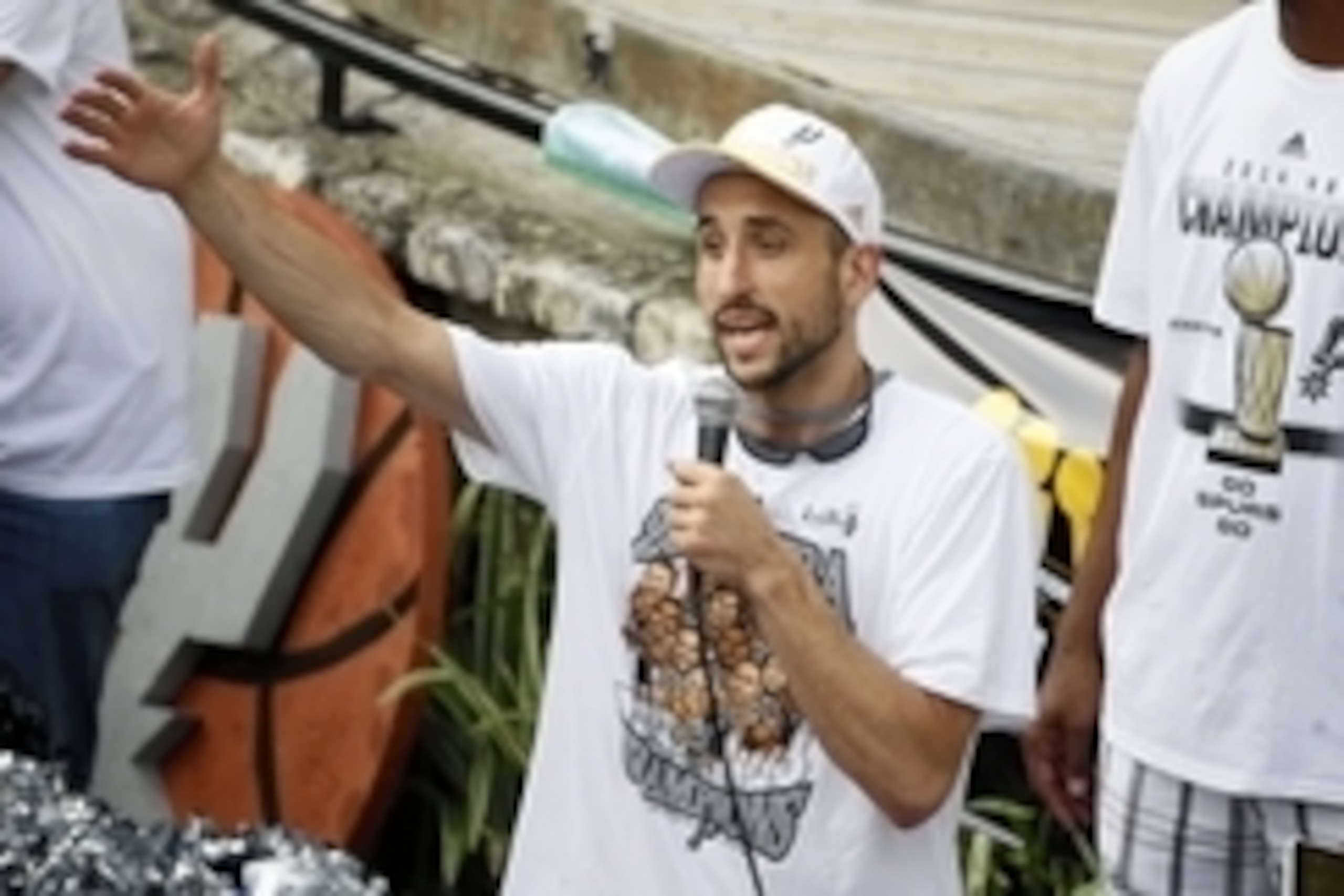 Jun 18, 2014; San Antonio, TX, USA; San Antonio Spurs guard Manu Ginobili (20) reacts to cheering fans during the NBA championship parade at San Antonio River Walk. Mandatory Credit: Soobum Im-USA TODAY Sports