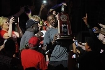 Apr 10, 2013; Louisville, KY, USA; Louisville Cardinals guard Russ Smith (2) carries the NCAA Midwest Region trophy through the crowd at the KFC YUM! Center during their celebration for winning the NCAA Men's Basketball Championship.  Mandatory Credit: Ja