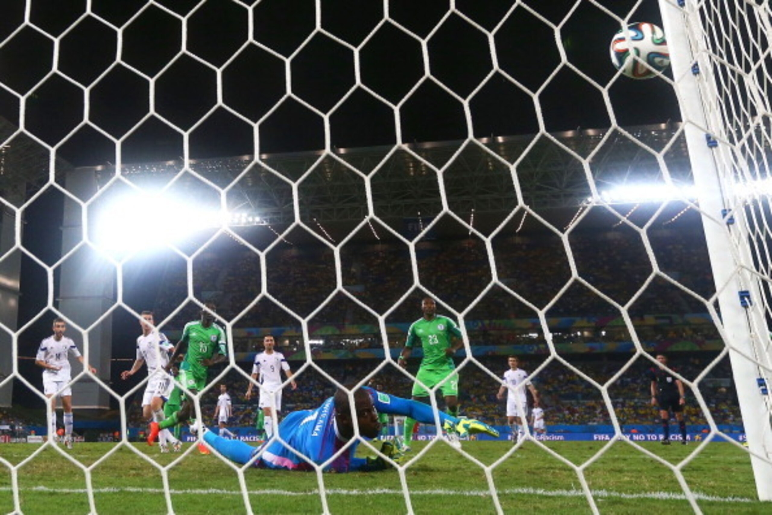 CUIABA, BRAZIL - JUNE 21: Vincent Enyeama of Nigeria makes a save on a shot by Edin Dzeko of Bosnia and Herzegovina during the 2014 FIFA World Cup Group F match between Nigeria and Bosnia-Herzegovina at Arena Pantanal on June 21, 2014 in Cuiaba, Brazil.  