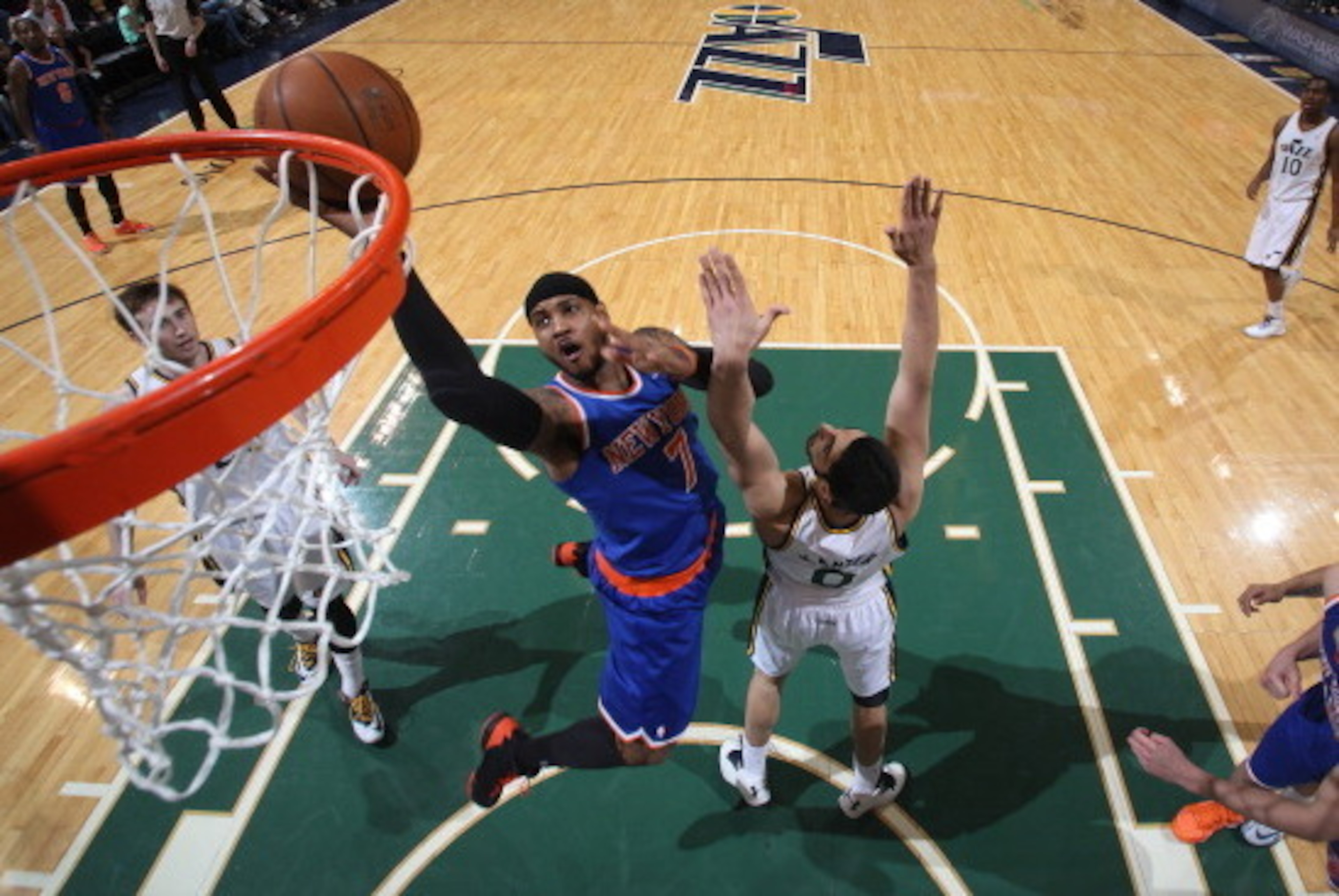 SALT LAKE CITY, UT - MARCH 31:  Carmelo Anthony #7 of the New York Knicks shoots against Enes Kanter #0 of the Utah Jazz at EnergySolutions Arena on March 31, 2014 in Salt Lake City, Utah. NOTE TO USER: User expressly acknowledges and agrees that, by down