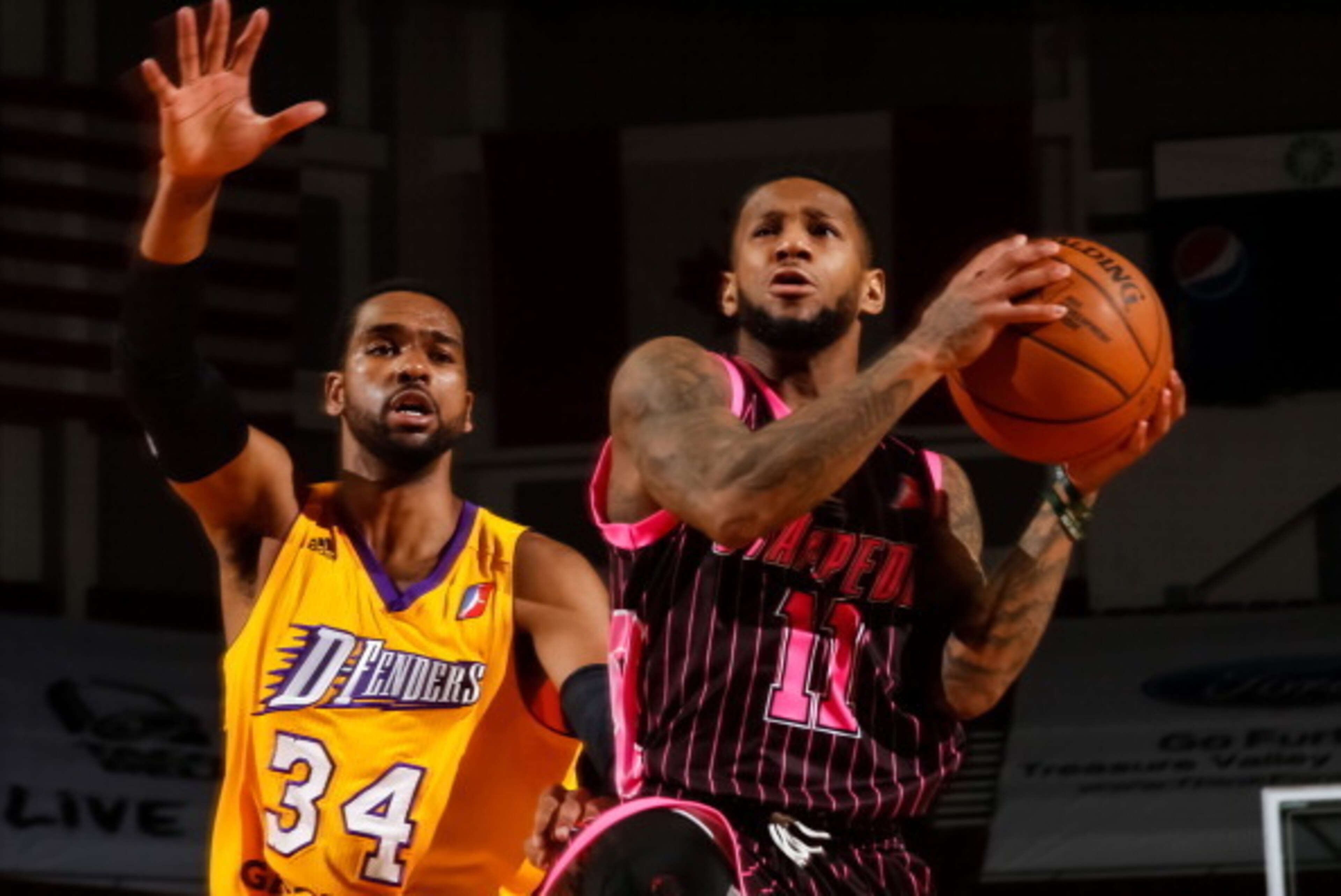 BOISE, ID - FEBRUARY 1:  Pierre Jackson #11 of the Idaho Stampede looks to the basket past James Southerland #34 of the Los Angeles D-Fenders during an NBA D-League game on February 1, 2014 at CenturyLink Arena in Boise, Idaho. The Stampede wore pink jers