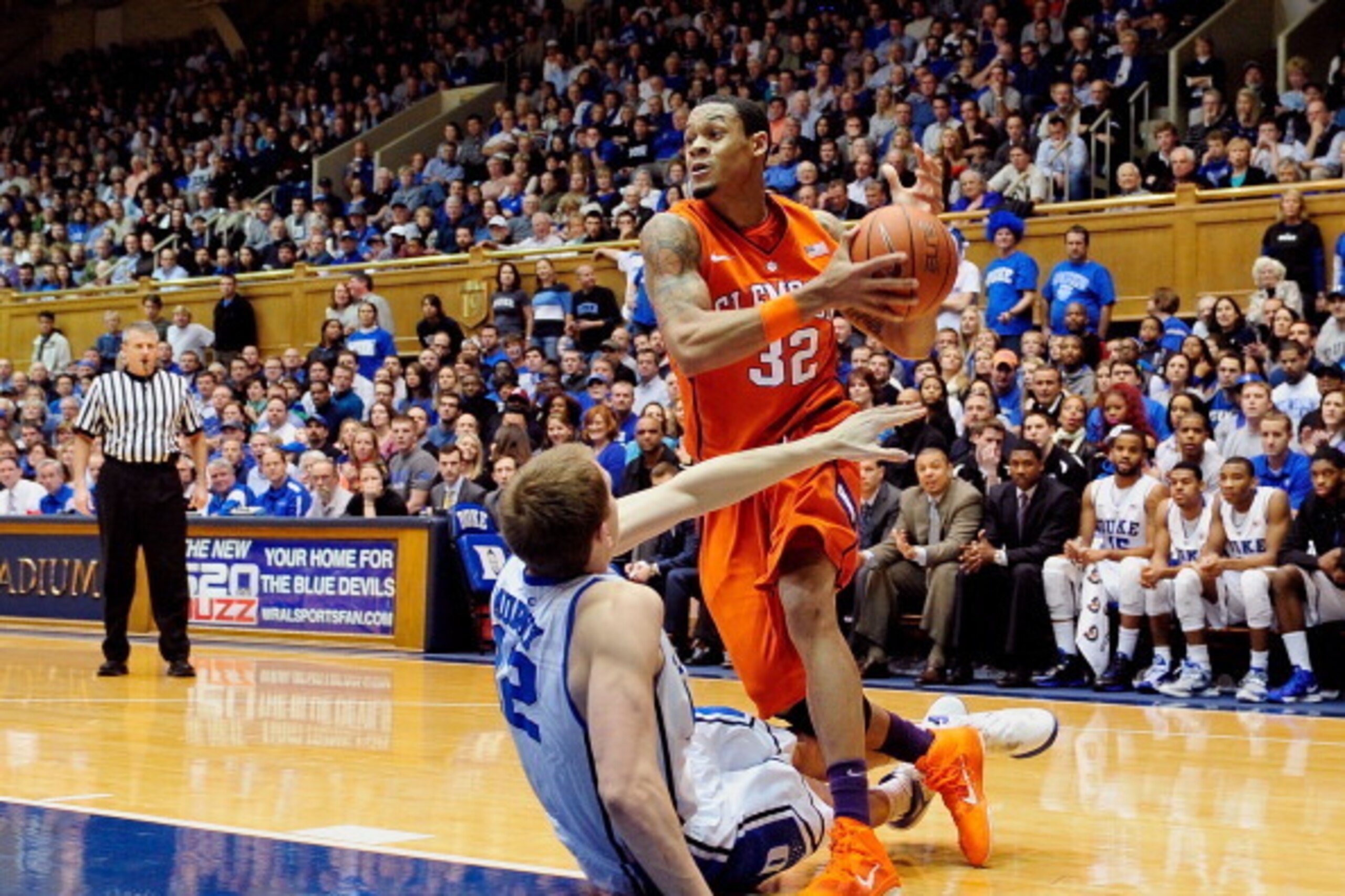 DURHAM, NC - JANUARY 08:  Alex Murphy #12 of the Duke Blue Devils draws a blocking foul as he defends a drive by K.J. McDaniels #32 of the Clemson Tigers during play at Cameron Indoor Stadium on January 8, 2013 in Durham, North Carolina.  (Photo by Grant 