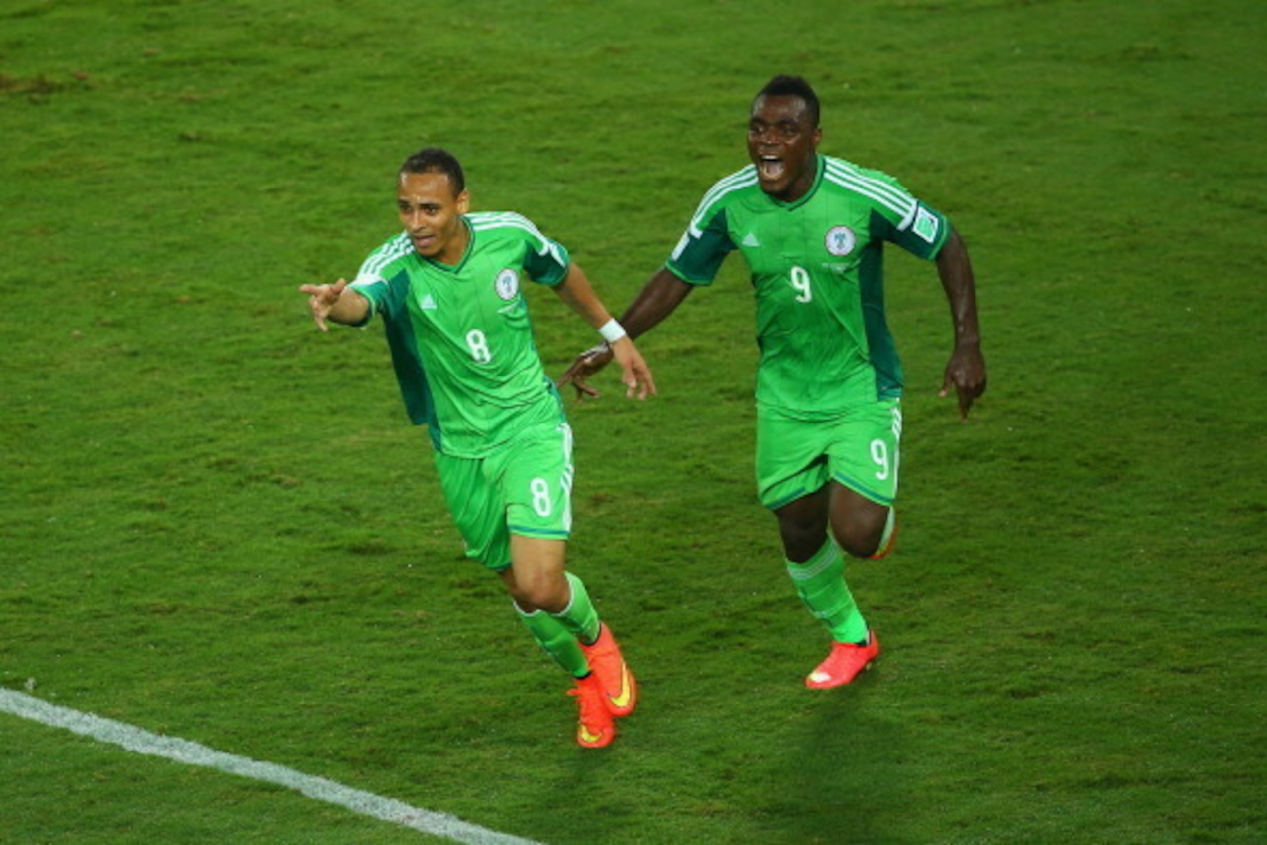 CUIABA, BRAZIL - JUNE 21: Peter Odemwingie of Nigeria (L) celebrates scoring his team's first goal with teammate Emmanuel Emenike during the 2014 FIFA World Cup Group F match between Nigeria and Bosnia-Herzegovina at Arena Pantanal on June 21, 2014 in Cui