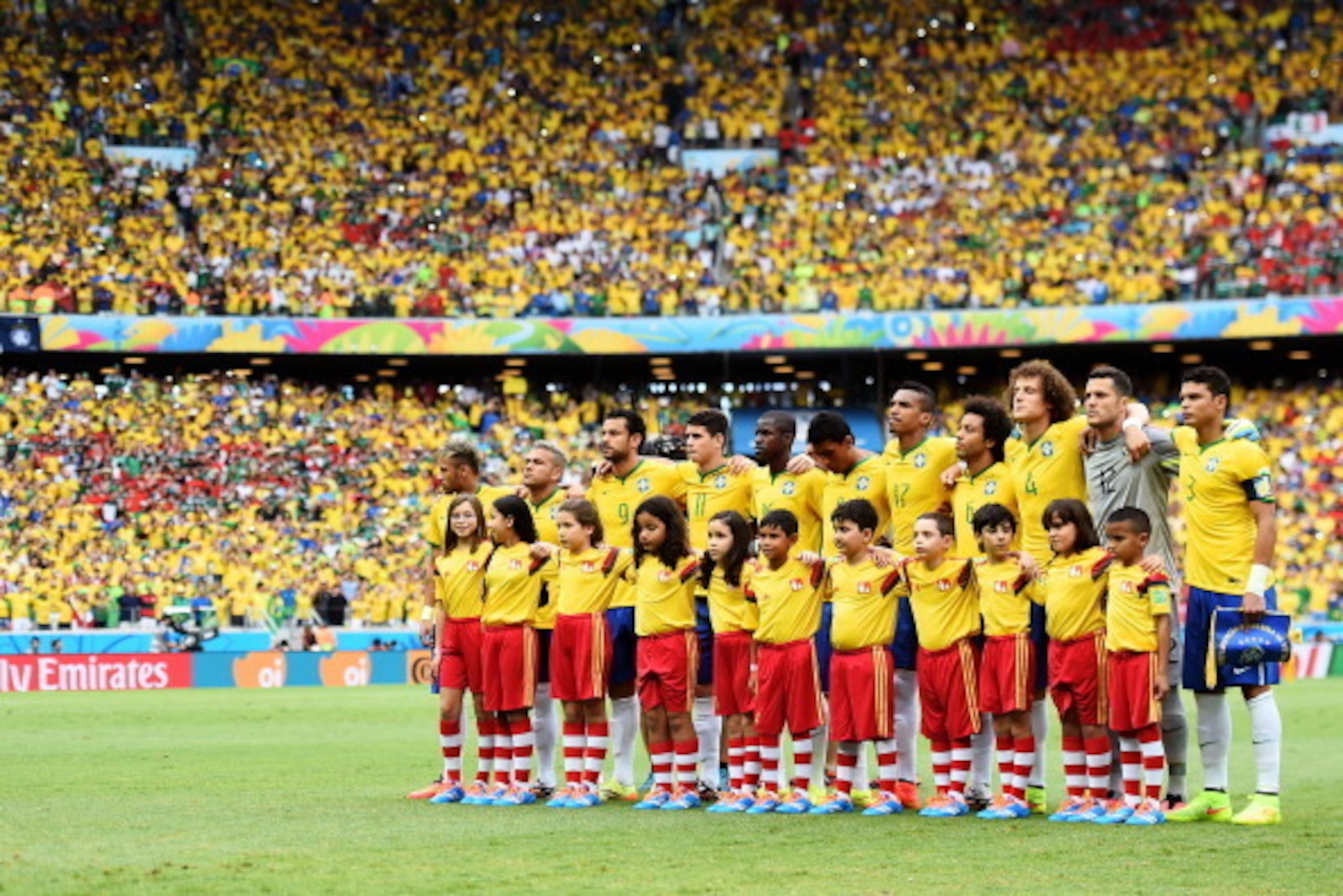FORTALEZA, BRAZIL - JUNE 17: Brazil line up for the National Anthems prior to the 2014 FIFA World Cup Brazil Group A match between Brazil and Mexico at Castelao on June 17, 2014 in Fortaleza, Brazil.  (Photo by Laurence Griffiths/Getty Images)