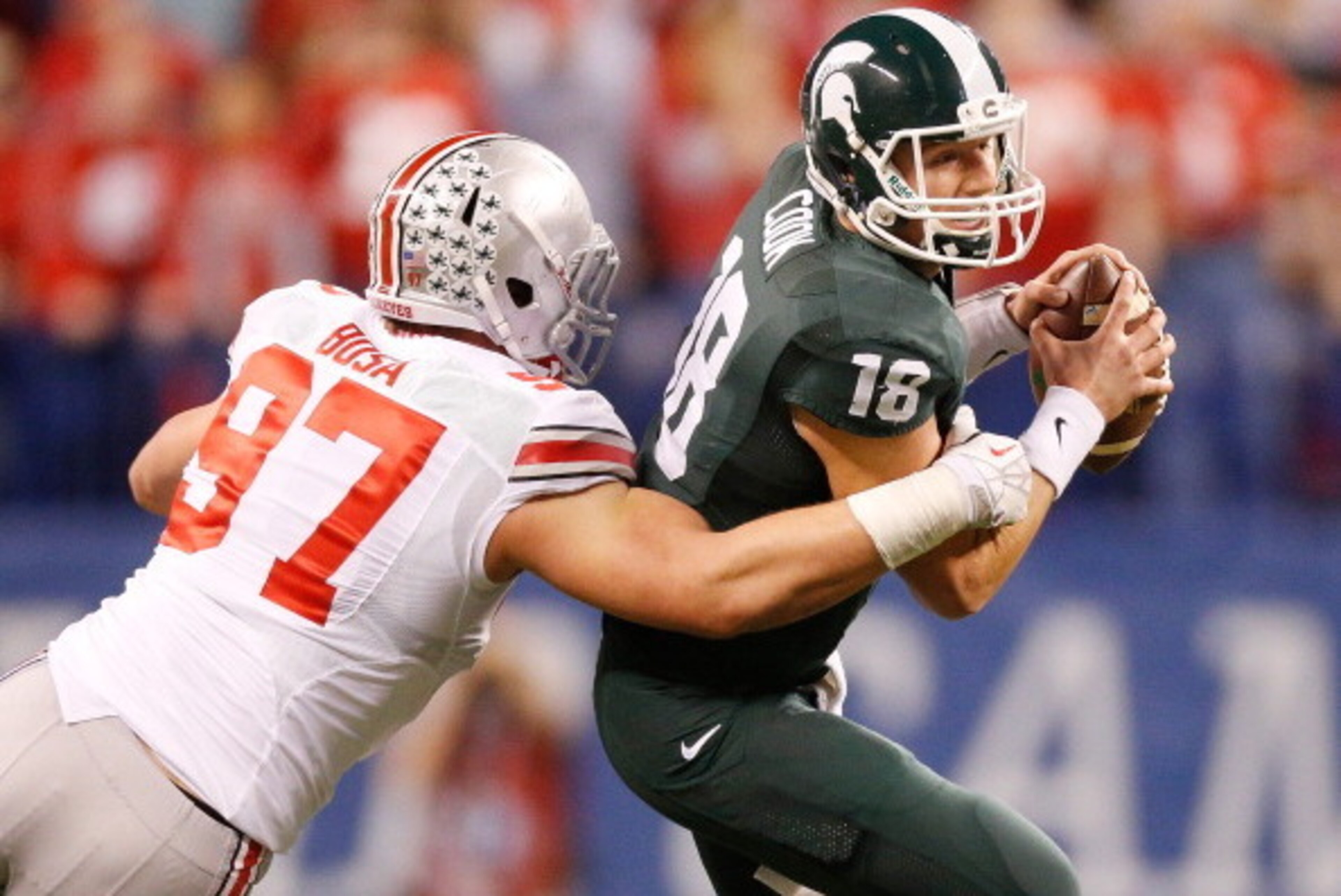 INDIANAPOLIS, IN - DECEMBER 07: Joey Bosa #97 of the Ohio State Buckeyes sacks Connor Cook #18 of the Michigan State Spartans in the first quarter during the Big 10 Conference Championship Game at Lucas Oil Stadium on December 7, 2013 in Indianapolis, In INDIANAPOLIS, IN - DECEMBER 07: Joey Bosa #97 of the Ohio State Buckeyes sacks Connor Cook #18 of the Michigan State Spartans in the first quarter during the Big 10 Conference Championship Game at Lucas Oil Stadium on December 7, 2013 in Indianapolis, In