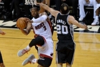 Jun 12, 2014; Miami, FL, USA; Miami Heat guard Dwyane Wade (3) goes up for a shot while defended by San Antonio Spurs guard Manu Ginobili (20) during the fourth quarter of game four of the 2014 NBA Finals at American Airlines Arena. San Antonio defeated M