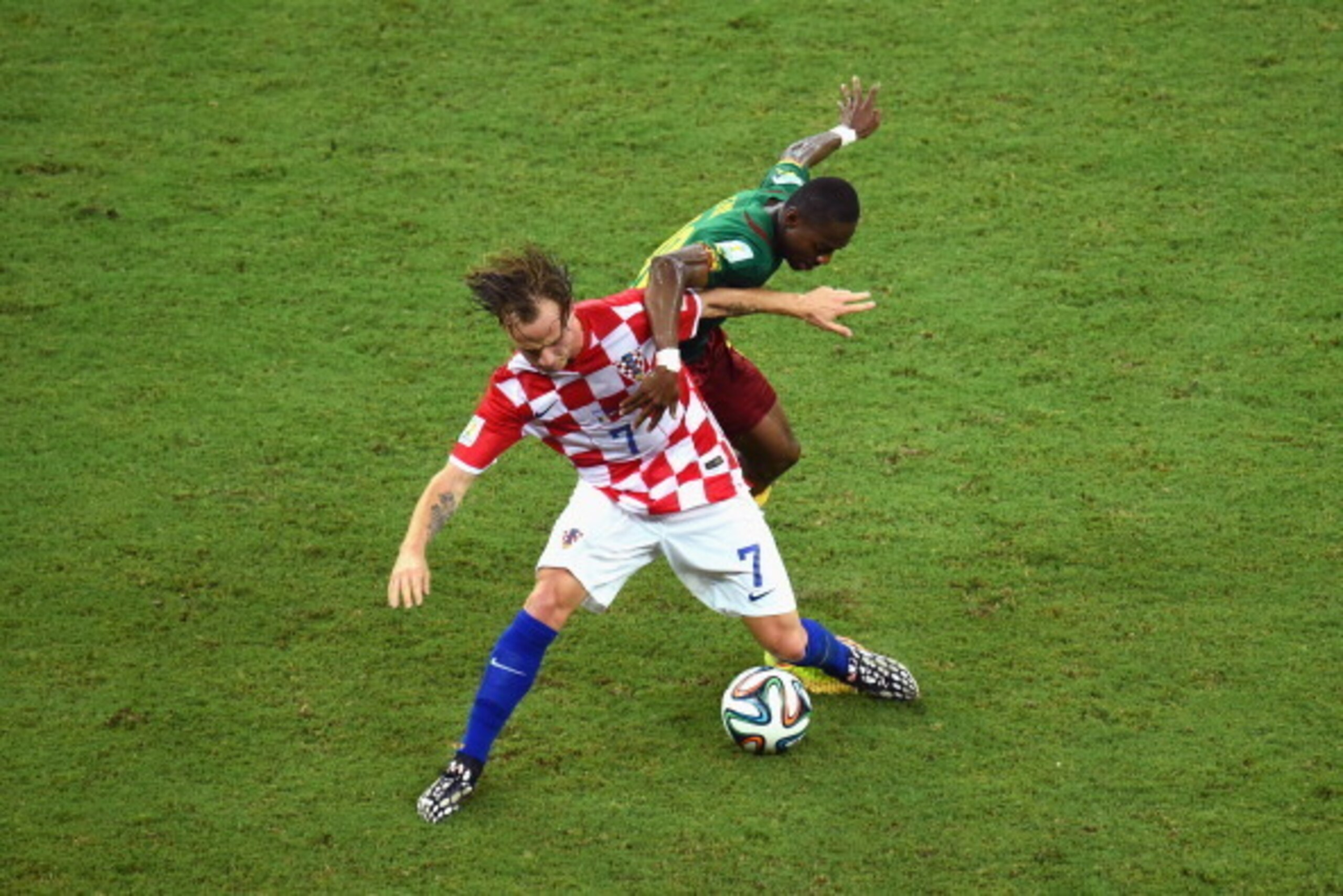 MANAUS, BRAZIL - JUNE 18: Ivan Rakitic of Croatia and Enoh Eyong of Cameroon compete for the ball during the 2014 FIFA World Cup Brazil Group A match between Cameroon and Croatia at Arena Amazonia on June 18, 2014 in Manaus, Brazil. (Photo by Stu Forst MANAUS, BRAZIL - JUNE 18: Ivan Rakitic of Croatia and Enoh Eyong of Cameroon compete for the ball during the 2014 FIFA World Cup Brazil Group A match between Cameroon and Croatia at Arena Amazonia on June 18, 2014 in Manaus, Brazil. (Photo by Stu Forst