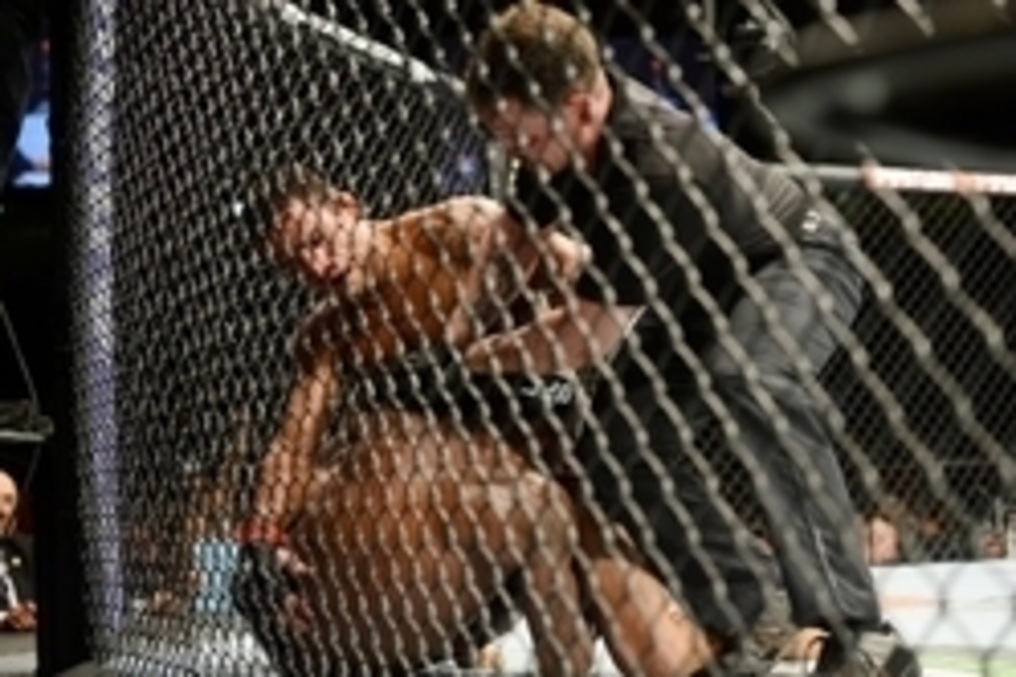 Jun 7, 2014; Albuquerque, NM, USA; Rafael Dos Anjos (red) and Jason High (blue) fight during their lightweight bout during UFC Fight Night 42 at Tingley Coliseum. Dos Anjos won via second round stoppage. Mandatory Credit: Joe Camporeale-USA TODAY Sports