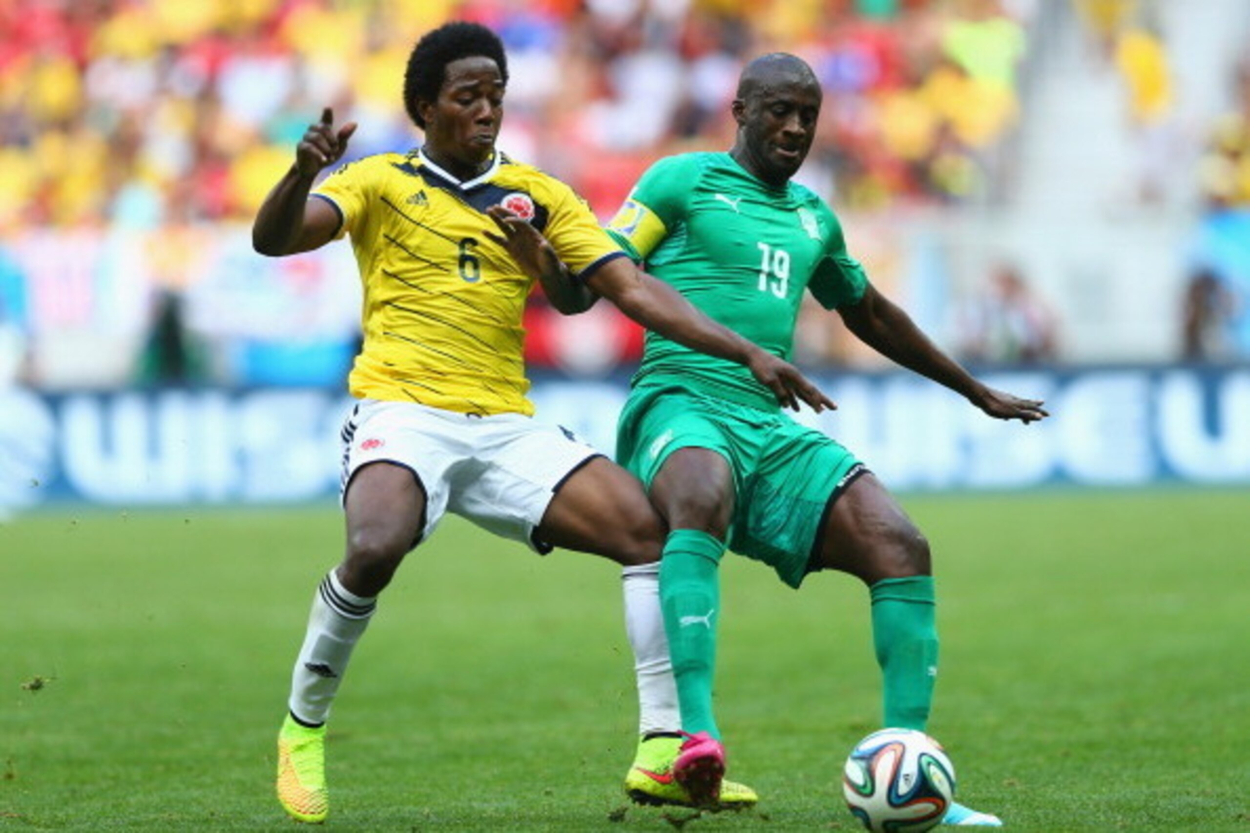 BRASILIA, BRAZIL - JUNE 19:  Carlos Sanchez (L) of Colombia vies with Yaya Toure of the Ivory Coast during the 2014 FIFA World Cup Brazil Group C match between Colombia and Cote D'Ivoire at Estadio Nacional on June 19, 2014 in Brasilia, Brazil.  (Photo by