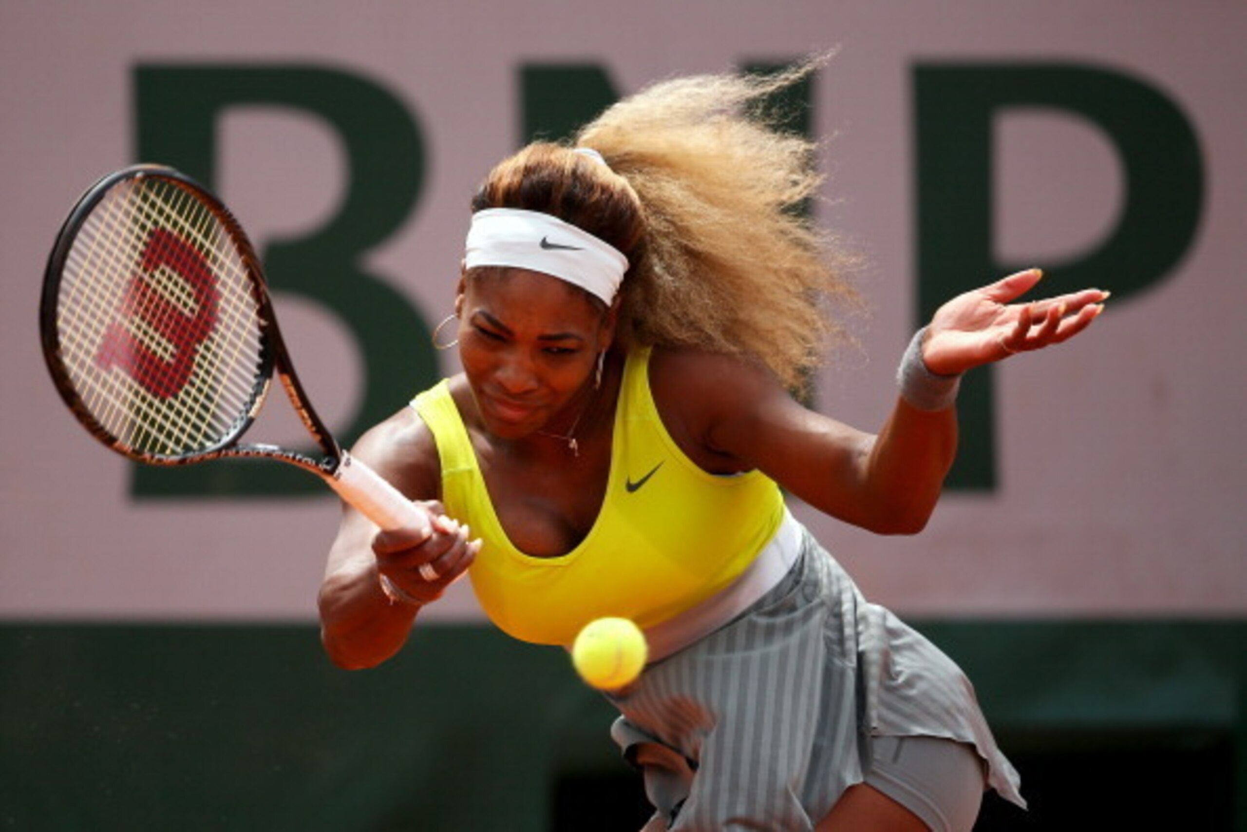 PARIS, FRANCE - MAY 28:  Serena Williams of the United States returns a shot during her women's singles match against Garbine Muguruza of Spain on day four of the French Open at Roland Garros on May 28, 2014 in Paris, France.  (Photo by Clive Brunskill/Ge