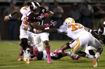STARKVILLE, MS - OCTOBER 13:  Running back LaDarius Perkins #27 of the Mississippi State Bulldogs gets around defensive back LaDarrell McNeil #33 of the Tennessee Volunteers for a big first down run on October 13, 2012 at Davis Wade Stadium in Starkville,