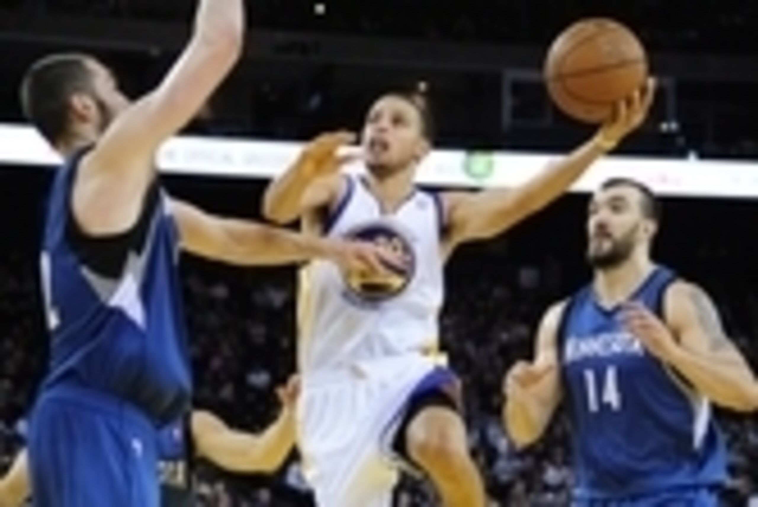 November 24, 2012; Oakland, CA, USA; Golden State Warriors shooting guard Stephen Curry (30) shoots the ball between Minnesota Timberwolves power forward Kevin Love (42, left) and center Nikola Pekovic (14) during the fourth quarter at ORACLE Arena. The W