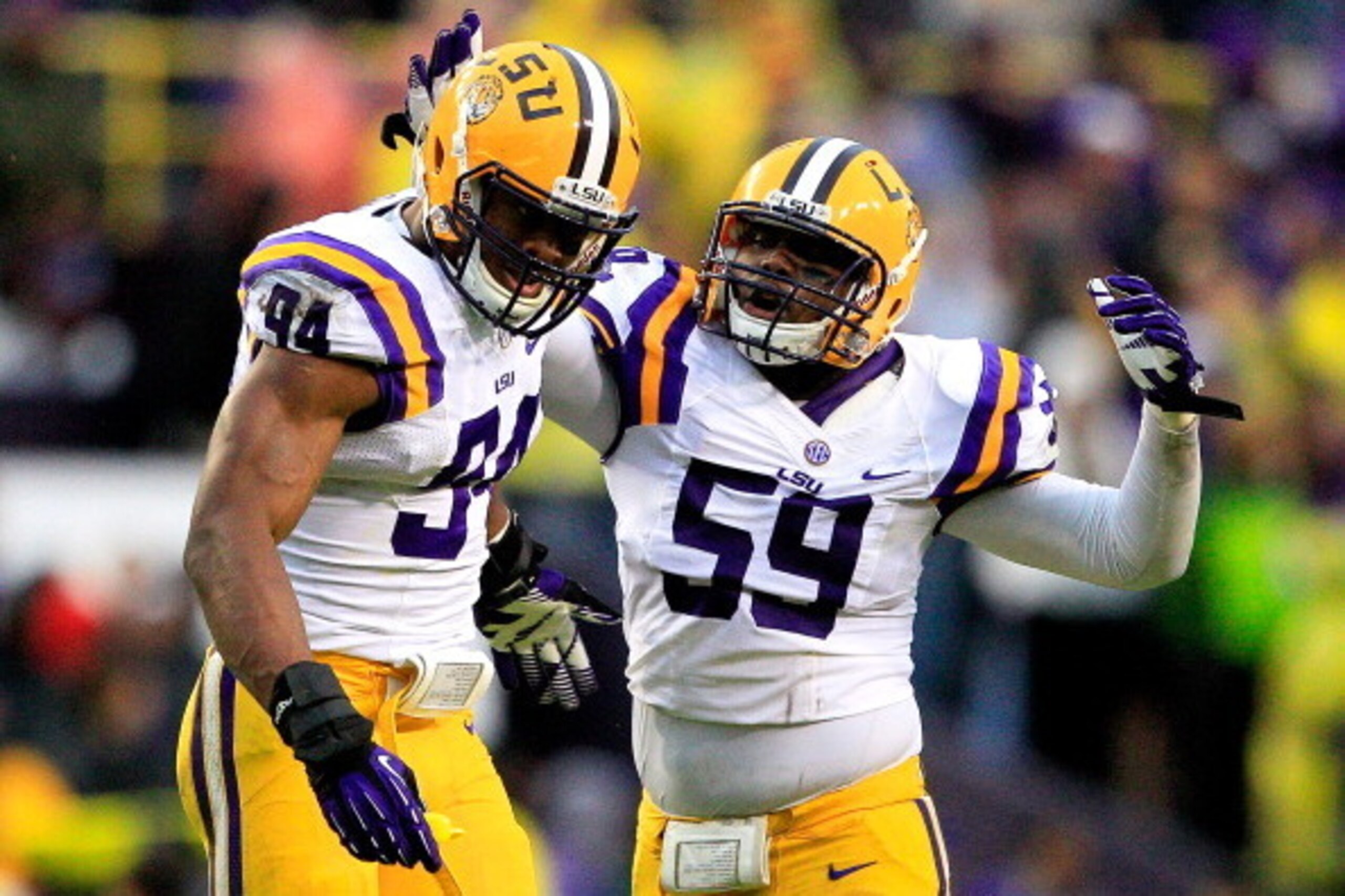 BATON ROUGE, LA - NOVEMBER 23:  Defensive end Danielle Hunter #94 of the LSU Tigers celebrates with his teammate defensive end Jermauria Rasco #59 after sacking quarterback  Johnny Manziel #2 of the Texas A&M Aggies at Tiger Stadium on November 23, 2013 i