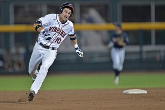 Omaha, NE - JUNE 23: Center fielder Brandon Downs #10 of the Virginia Cavaliers triples against the Vanderbilt Commodores in the fifth inning during game one of the College World Series Championship on June 23, 2014 at TD Ameritrade Park in Omaha, Nebrask