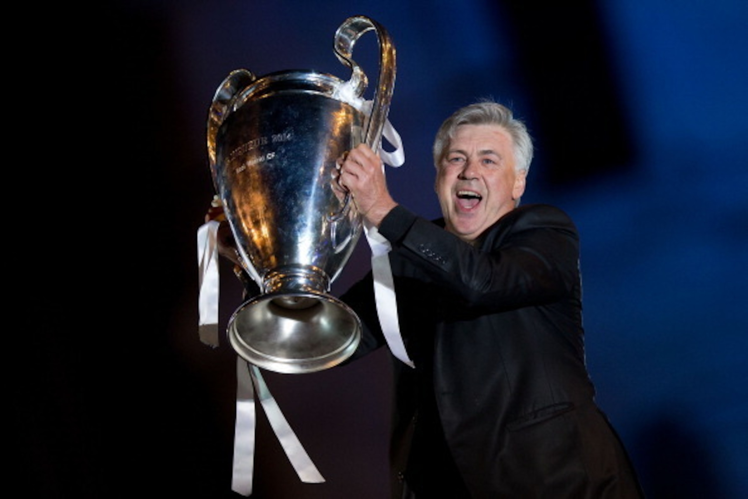 MADRID, SPAIN - MAY 25: Head coach Carlo Ancelotti of Real Madrid CF holds the UEFA Champions League cup celebrating their victory on the UEFA Champions League Final match against Club Atletico de Madrid at Cibeles square on the early morning of May, 25, MADRID, SPAIN - MAY 25: Head coach Carlo Ancelotti of Real Madrid CF holds the UEFA Champions League cup celebrating their victory on the UEFA Champions League Final match against Club Atletico de Madrid at Cibeles square on the early morning of May, 25,