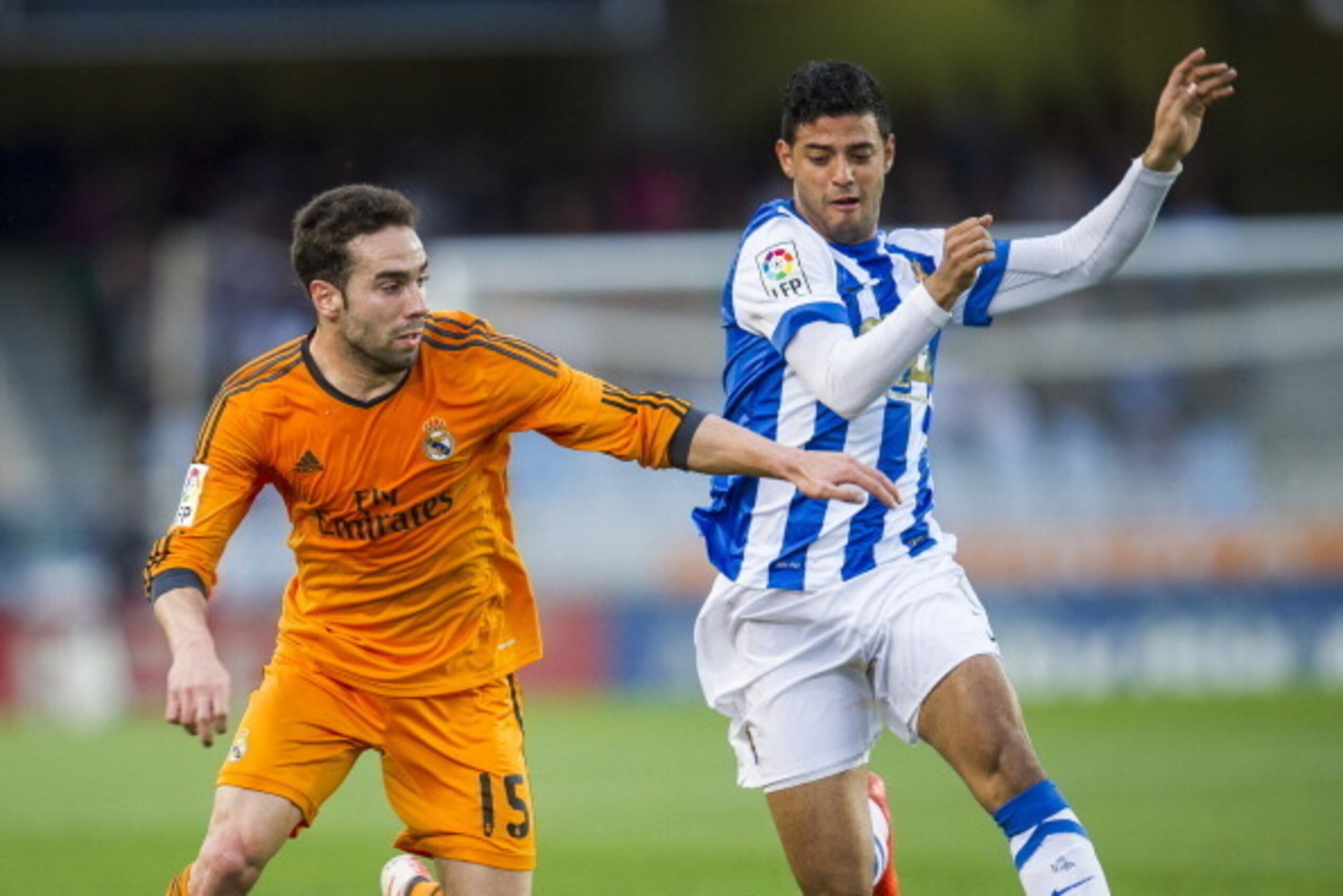 SAN SEBASTIAN, SPAIN - APRIL 05:  Daniel Carvajal of Real Madrid CF duels for the ball with Carlos Vela of Real Sociedad during the La Liga match between Real Sociedad and Real Madrid CF at Estadio Anoeta on April 5, 2014 in San Sebastian, Spain.  (Photo 