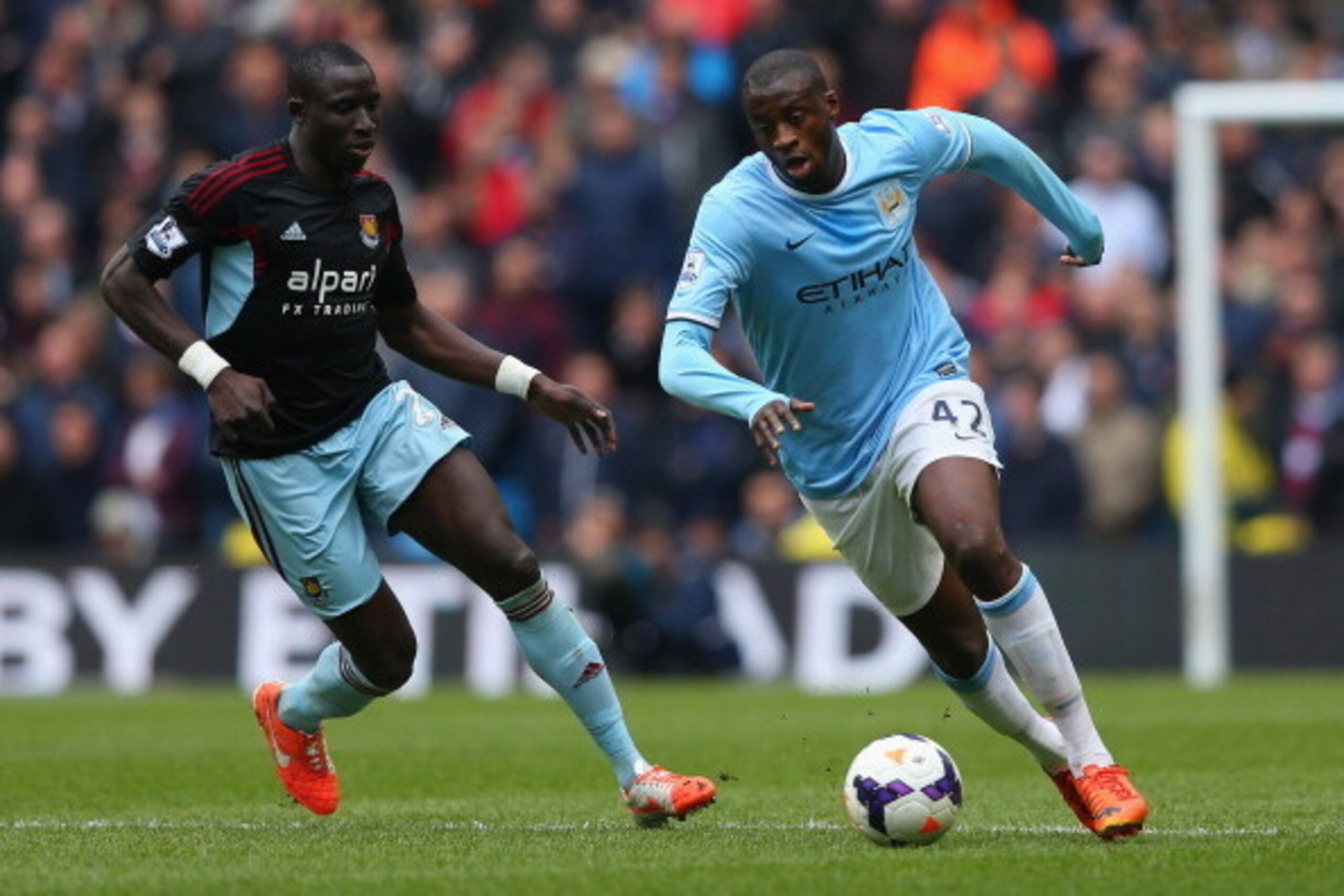 MANCHESTER, ENGLAND - MAY 11:  Yaya Toure of Manchester City competes with Mohamed Diame of West Ham United during the Barclays Premier League match between Manchester City and West Ham United at the Etihad Stadium on May 11, 2014 in Manchester, England. 