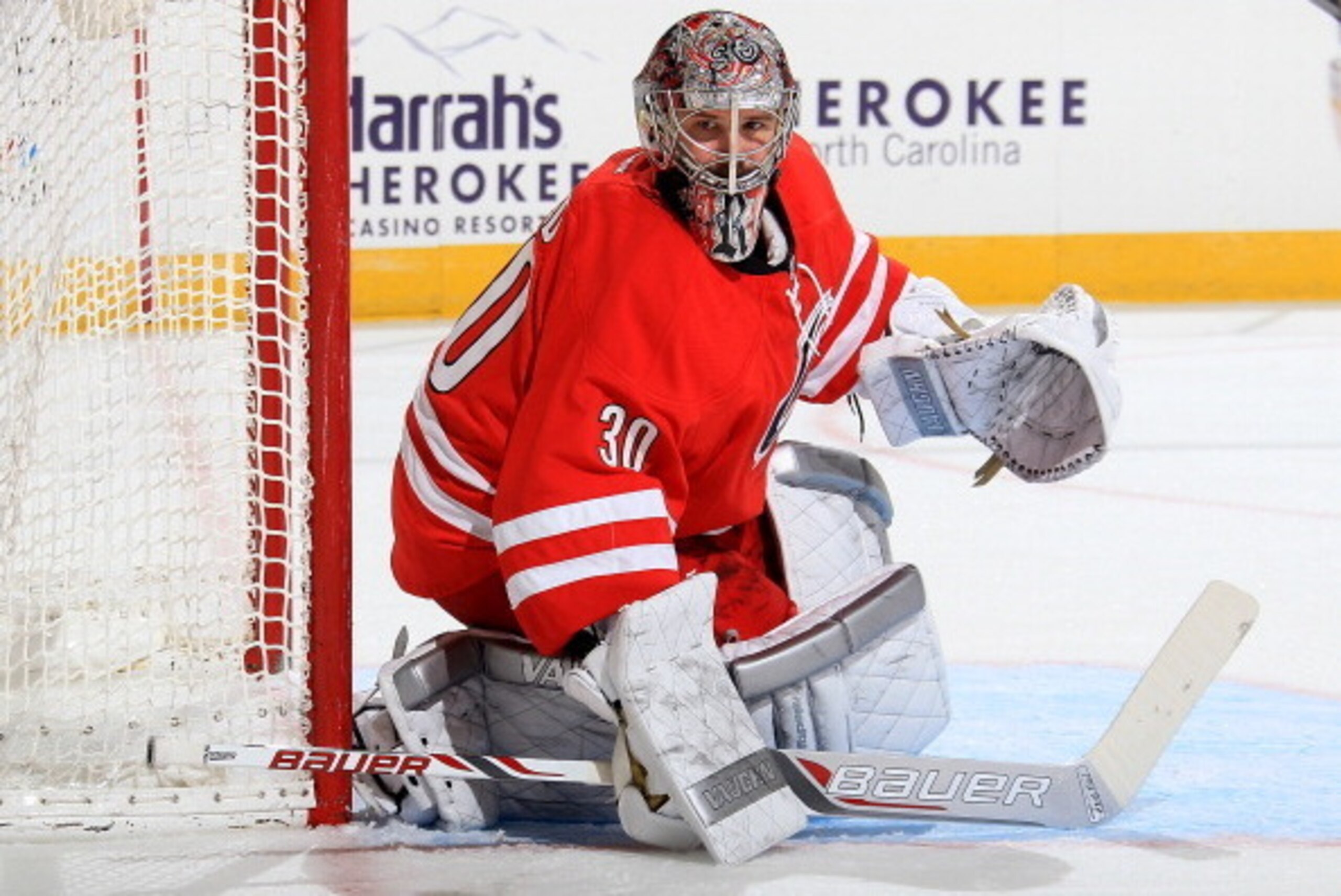 RALEIGH, NC - MARCH 11: Cam Ward #30 of the Carolina Hurricanes goes down in the crease to protect the net during their NHL game against the New York Rangers at PNC Arena on March 11, 2014 in Raleigh, North Carolina.  (Photo by Gregg Forwerck/NHLI via Get