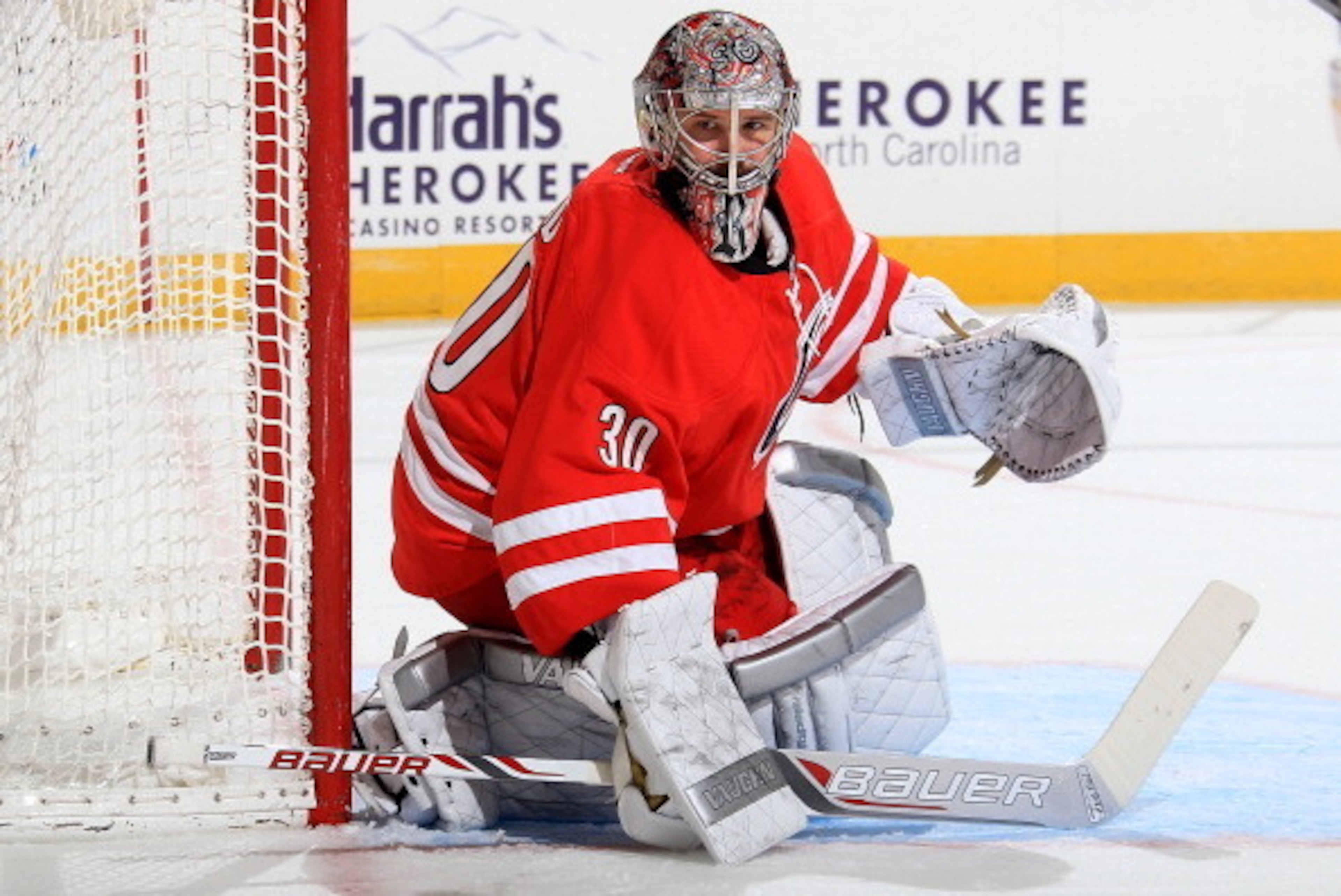 RALEIGH, NC - MARCH 11: Cam Ward #30 of the Carolina Hurricanes goes down in the crease to protect the net during their NHL game against the New York Rangers at PNC Arena on March 11, 2014 in Raleigh, North Carolina.  (Photo by Gregg Forwerck/NHLI via Get