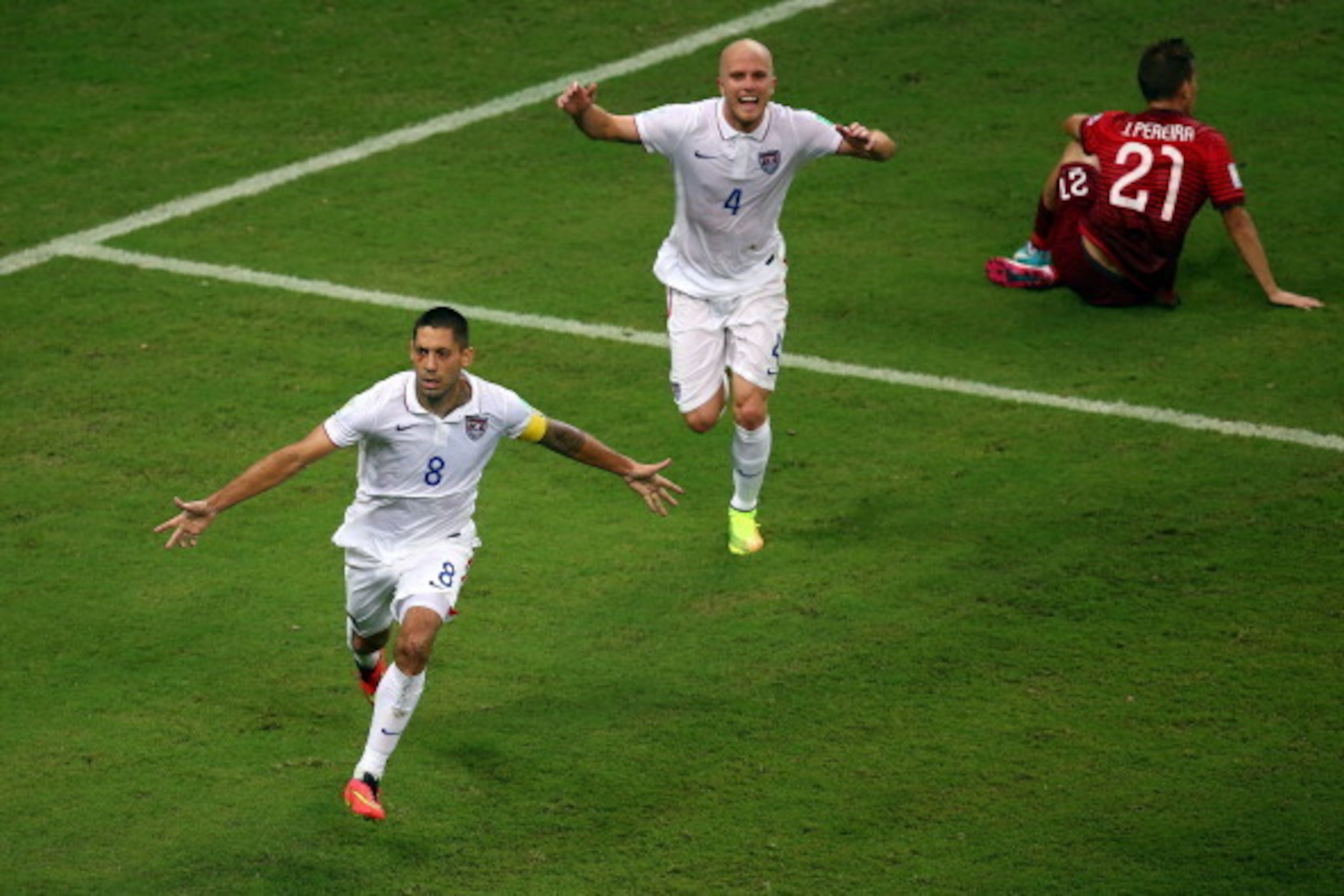 MANAUS, BRAZIL - JUNE 22: Clint Dempsey of the United States celebrates scoring his team's second goal with teammate Michael Bradley as Joao Pereira of Portugal looks on during the 2014 FIFA World Cup Brazil Group G match between the United States and Por