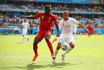 BELO HORIZONTE, BRAZIL - JUNE 17:  Romelu Lukaku of Belgium challenges Madjid Bougherra of Algeria during the 2014 FIFA World Cup Brazil Group H match between Belgium and Algeria at Estadio Mineirao on June 17, 2014 in Belo Horizonte, Brazil.  (Photo by P