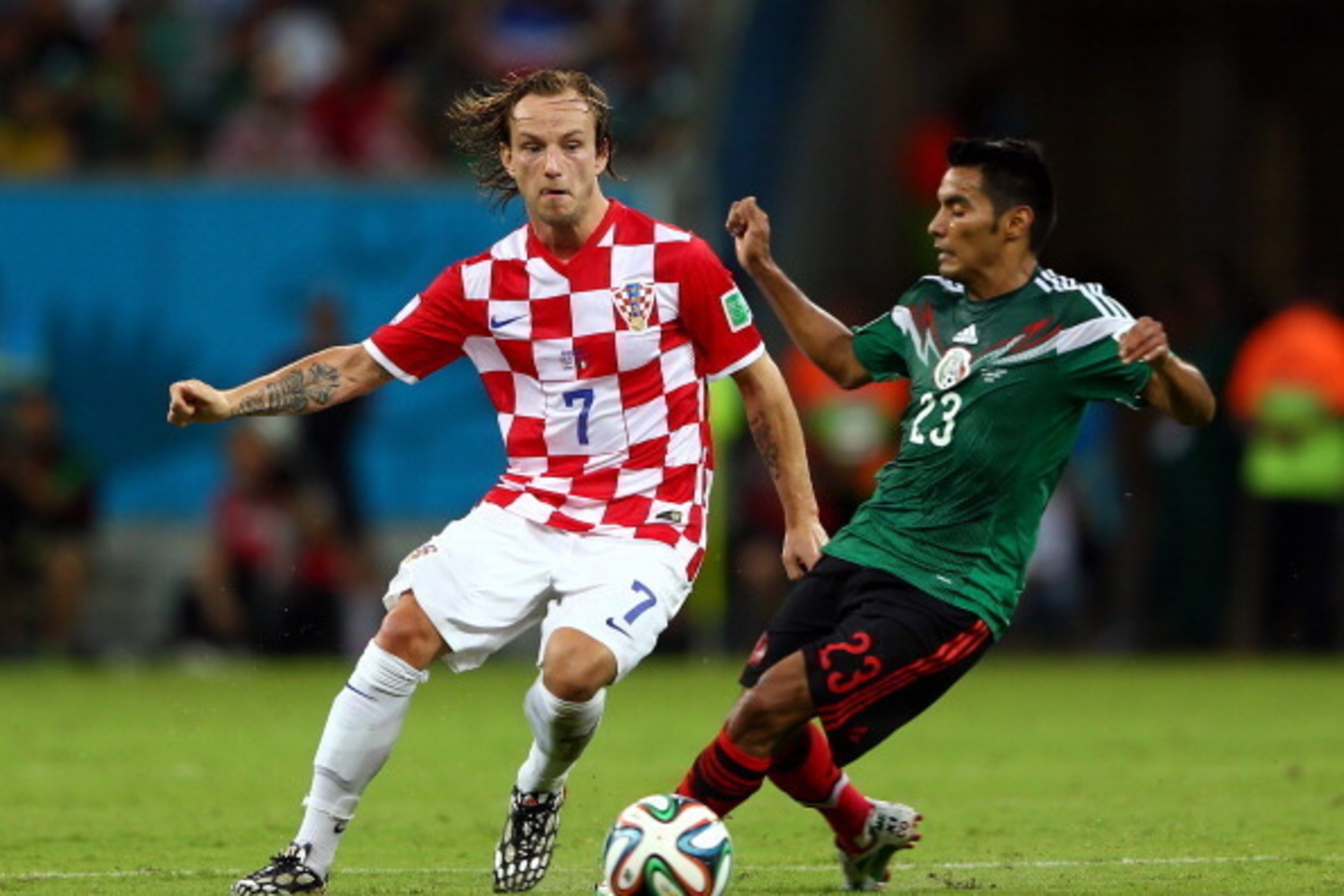 RECIFE, BRAZIL - JUNE 23:  Ivan Rakitic of Croatia and Jose Juan Vazquez of Mexico compete for the ball during the 2014 FIFA World Cup Brazil Group A match between Croatia and Mexico at Arena Pernambuco on June 23, 2014 in Recife, Brazil.  (Photo by Micha